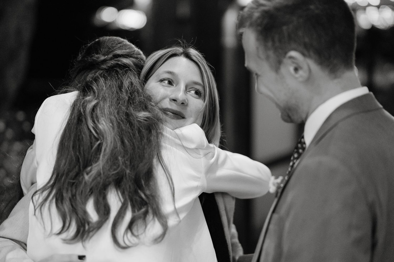 Black and white candid moments captured during an intimate wedding celebration.