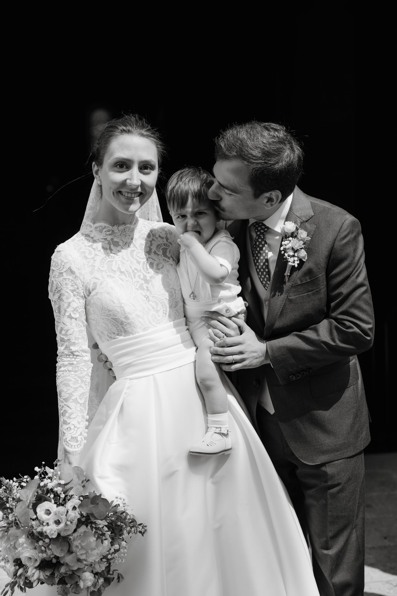 Intimate black and white wedding moments captured in dramatic lighting.