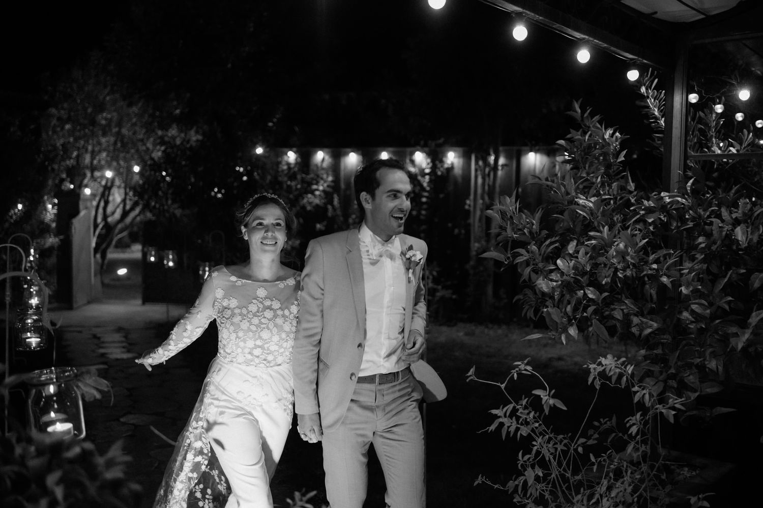 String lights create a magical atmosphere over an outdoor evening celebration.
