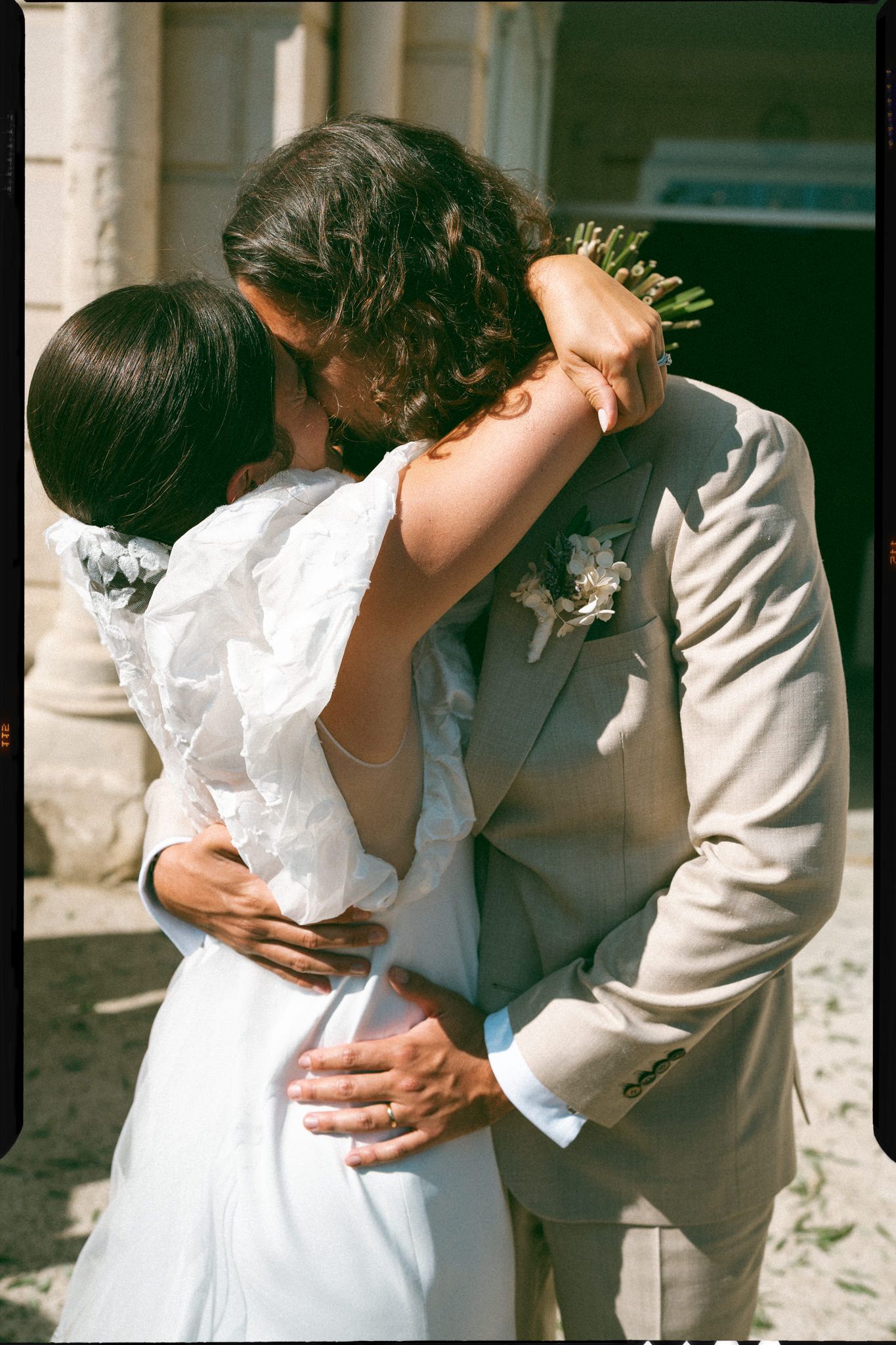 A romantic sequence of wedding photos showing a couple in white dress and gray suit embracing in natural sunlight.