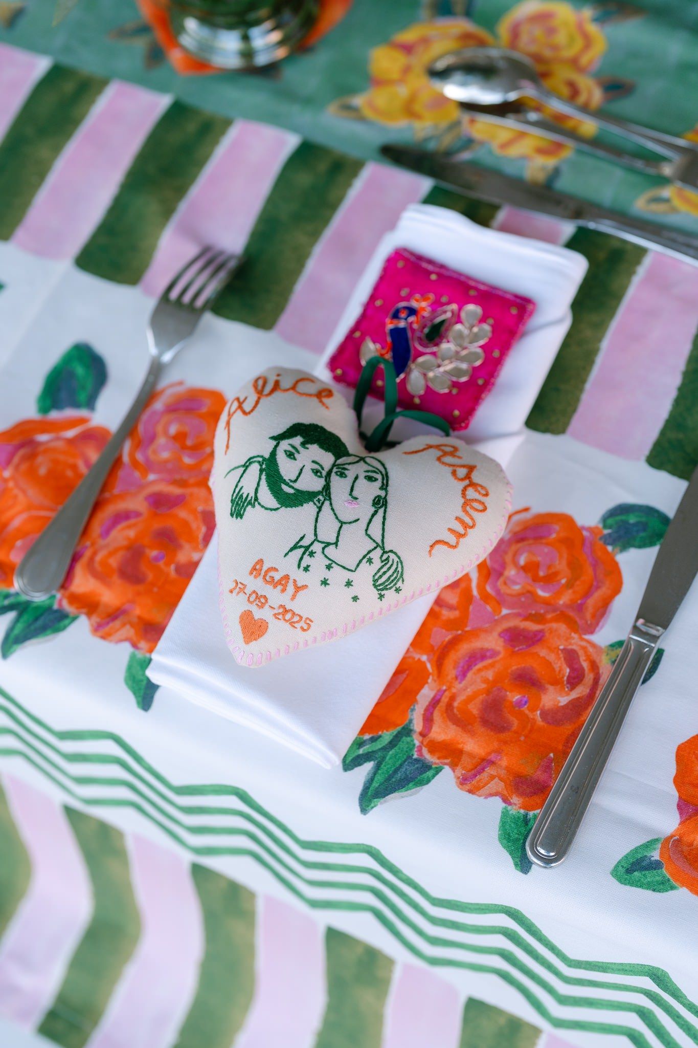 Close-up of decorative napkins with orange floral prints and green chevron patterns.