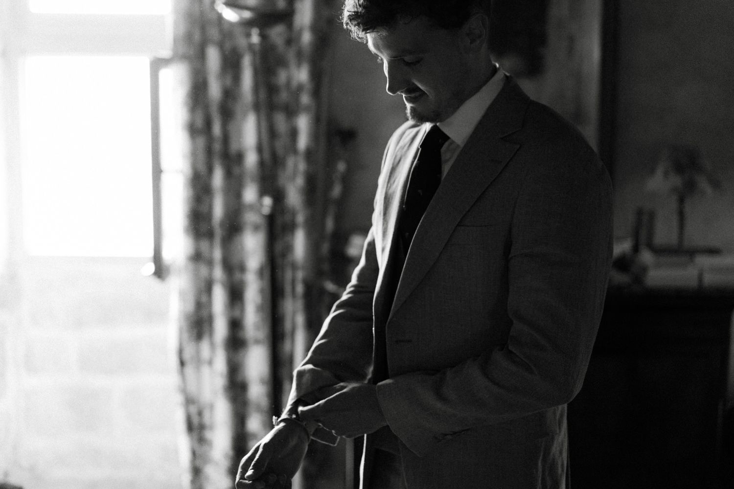 Dramatic black and white silhouettes of wedding day preparations.