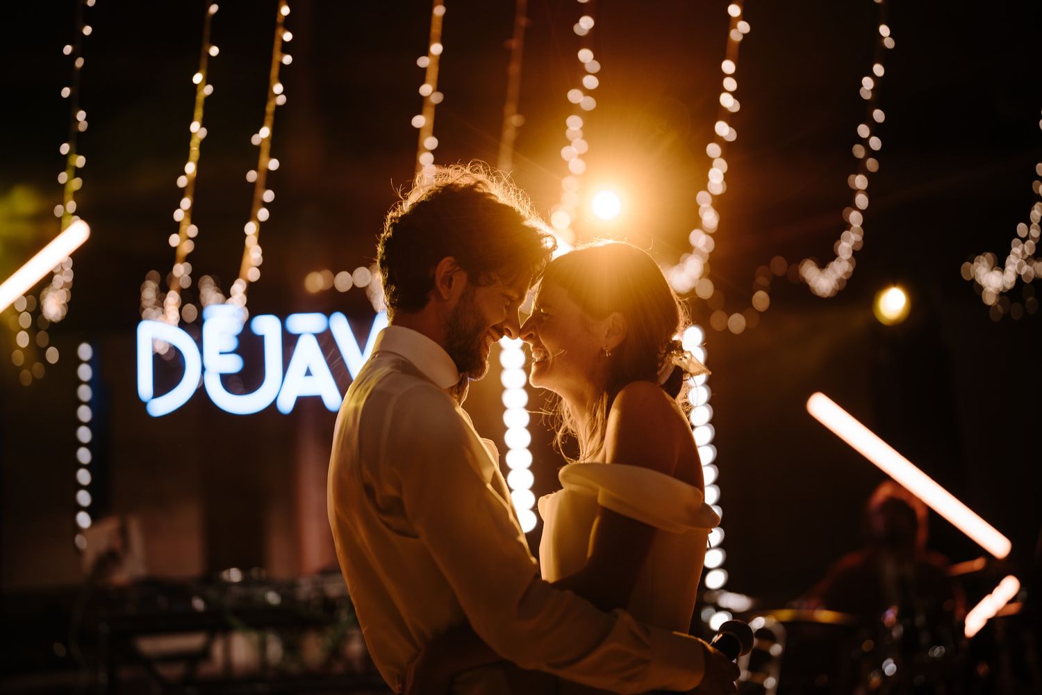 String lights create a warm ambiance at an evening outdoor event with glowing decorations.