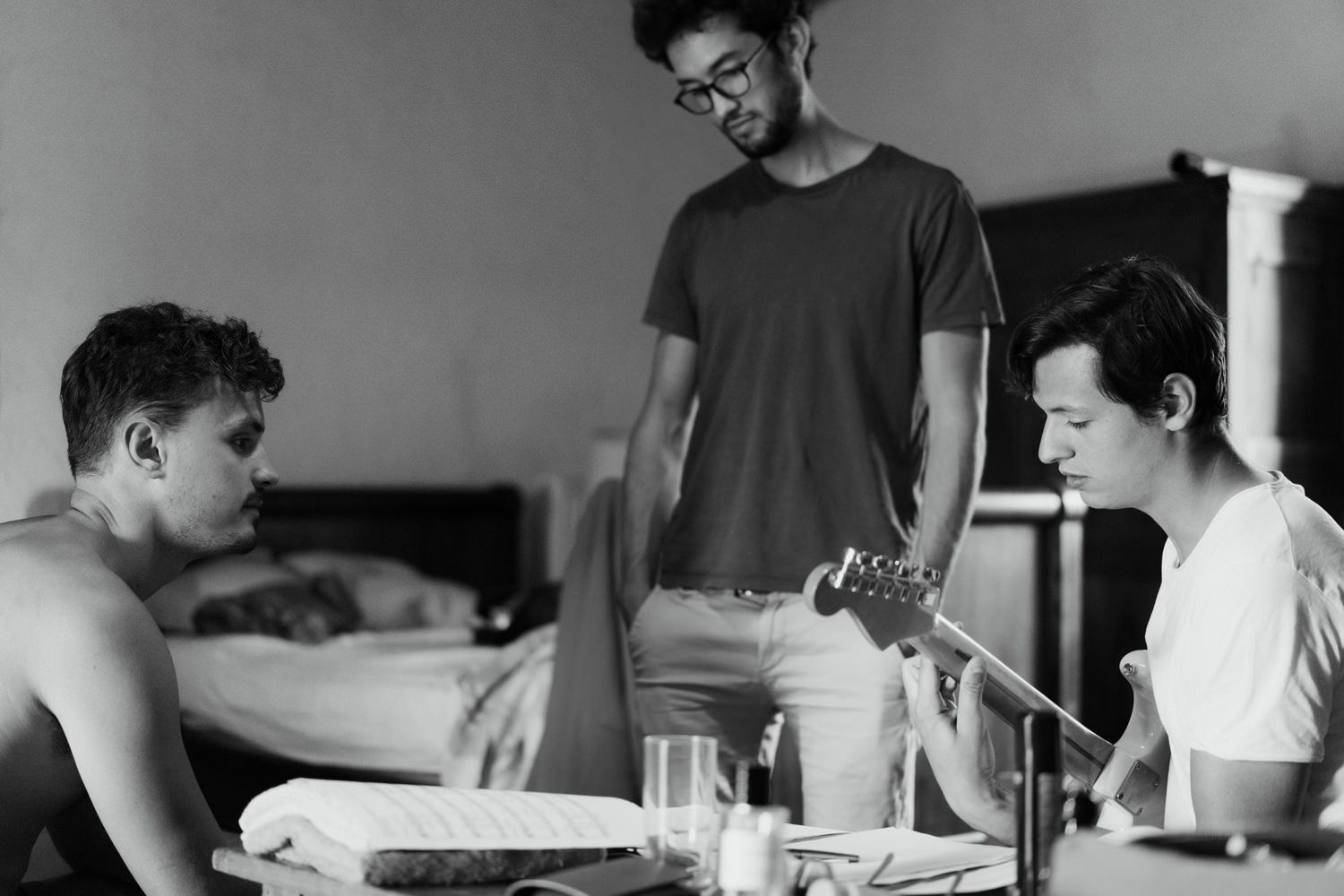 Black and white photographs showing daily activities in an interior space.