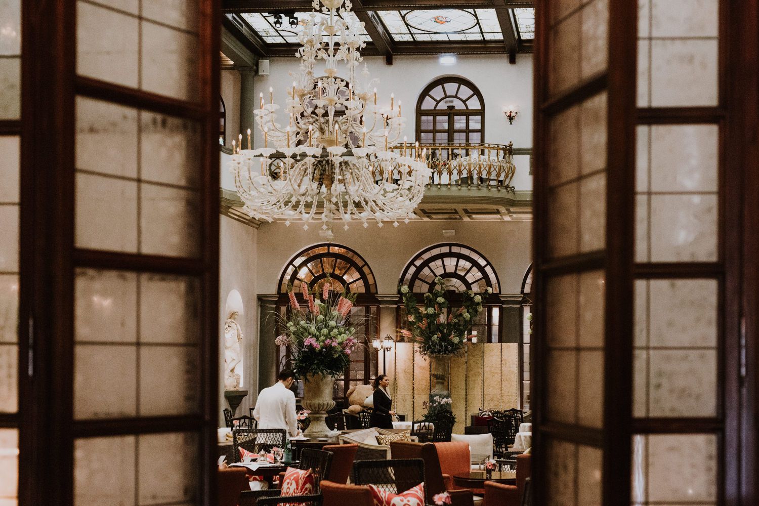 Luxurious interior space with crystal chandeliers and ornate decor.