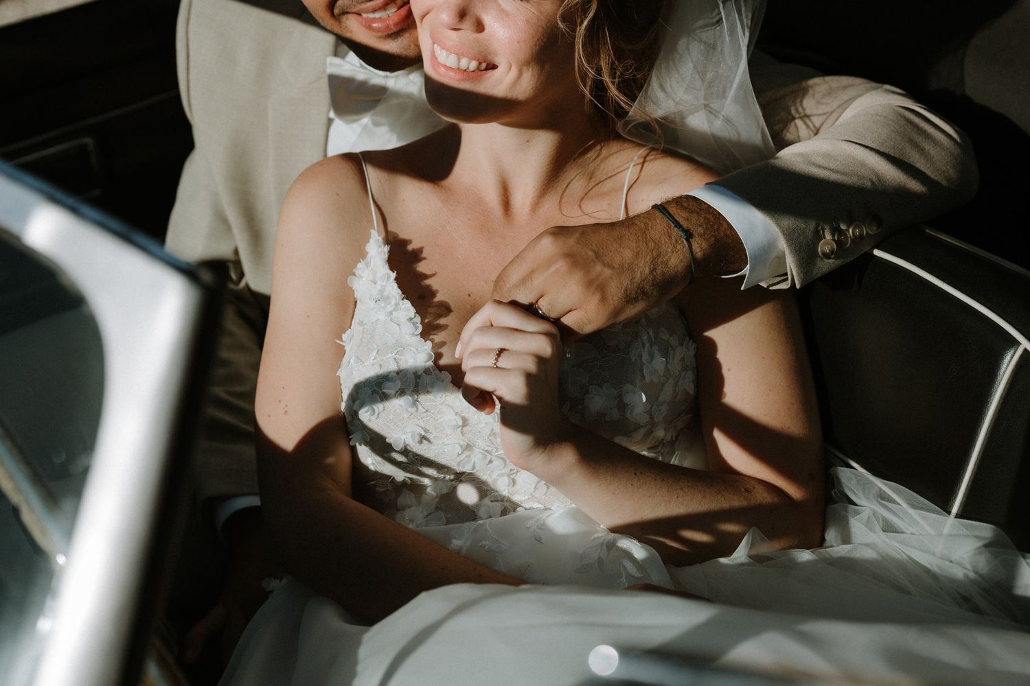 An intimate moment captured inside a classic car with natural sunlight streaming in.