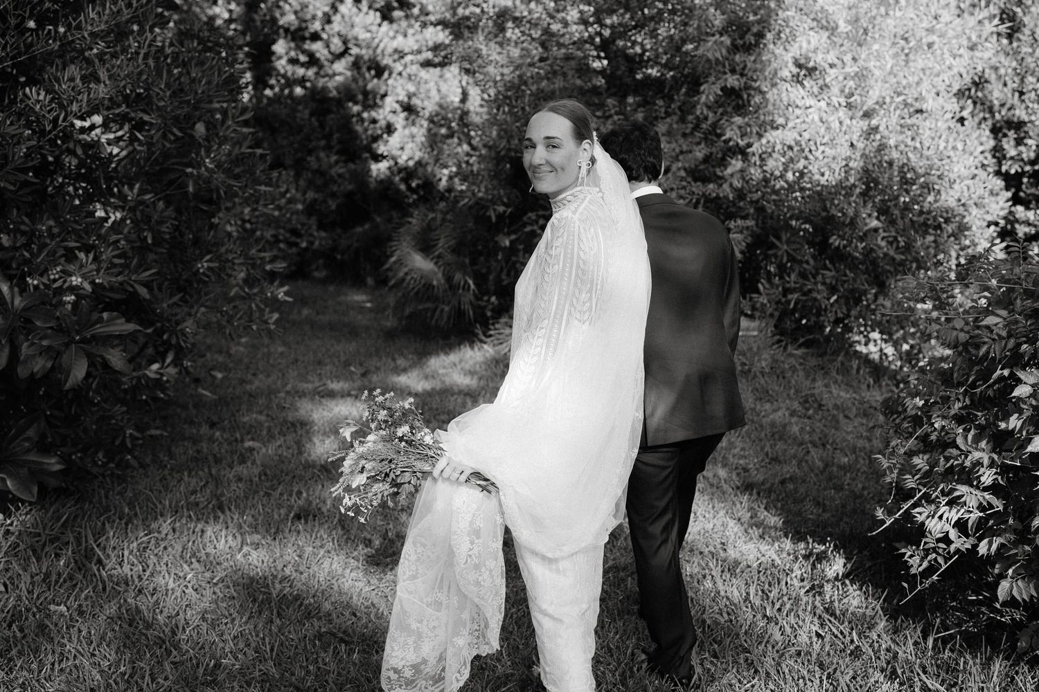 An artistic black and white series of wedding moments in a garden setting.