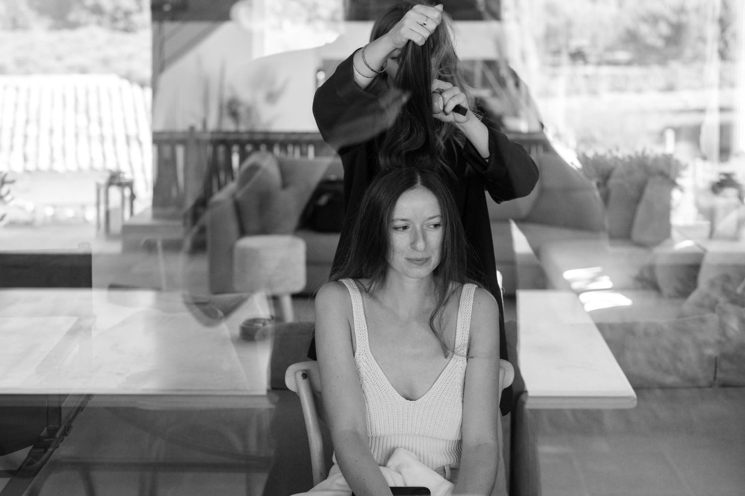 Black and white sequence showing people working at a table in natural light.