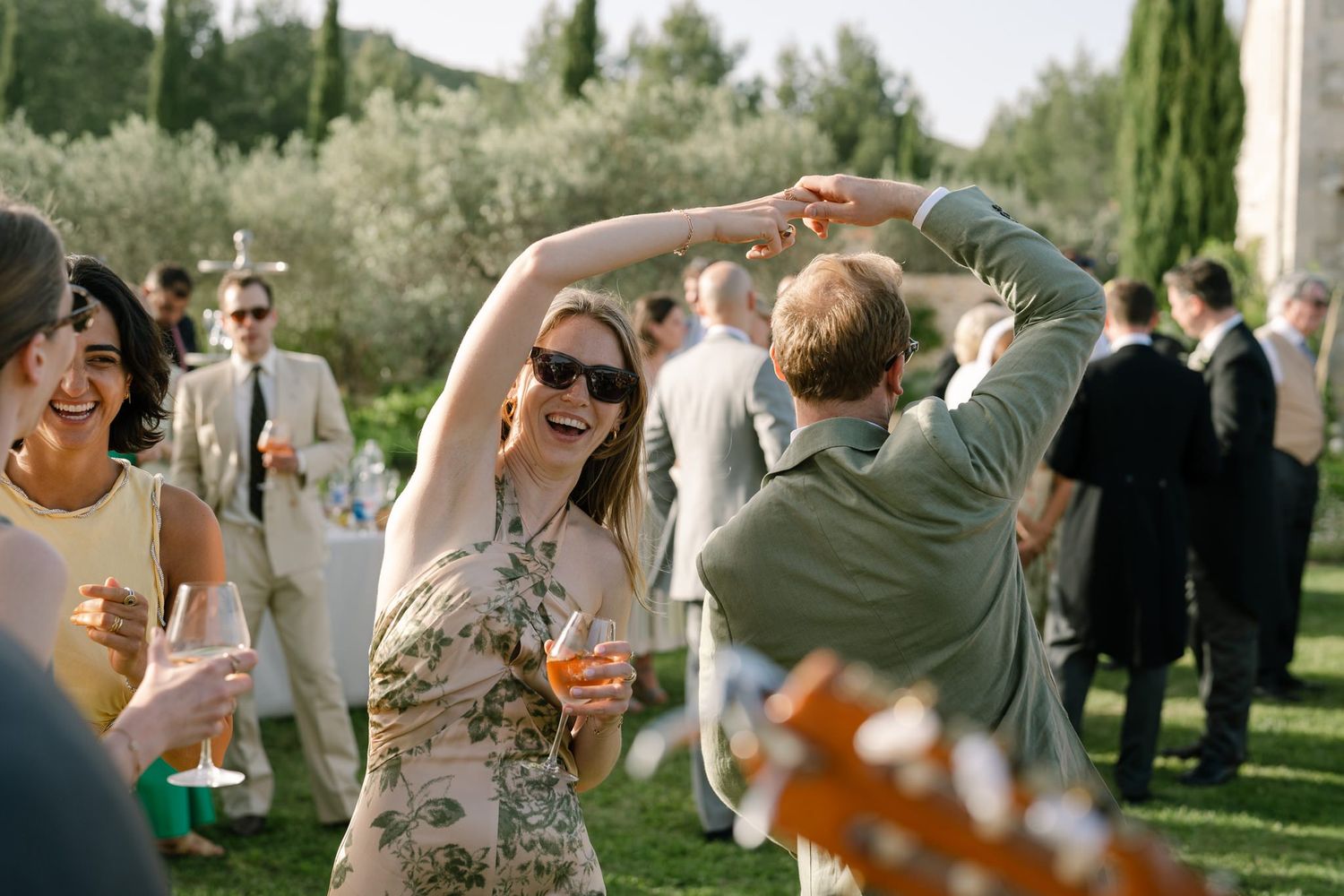 Wedding guests mingle and socialize during an outdoor cocktail reception.
