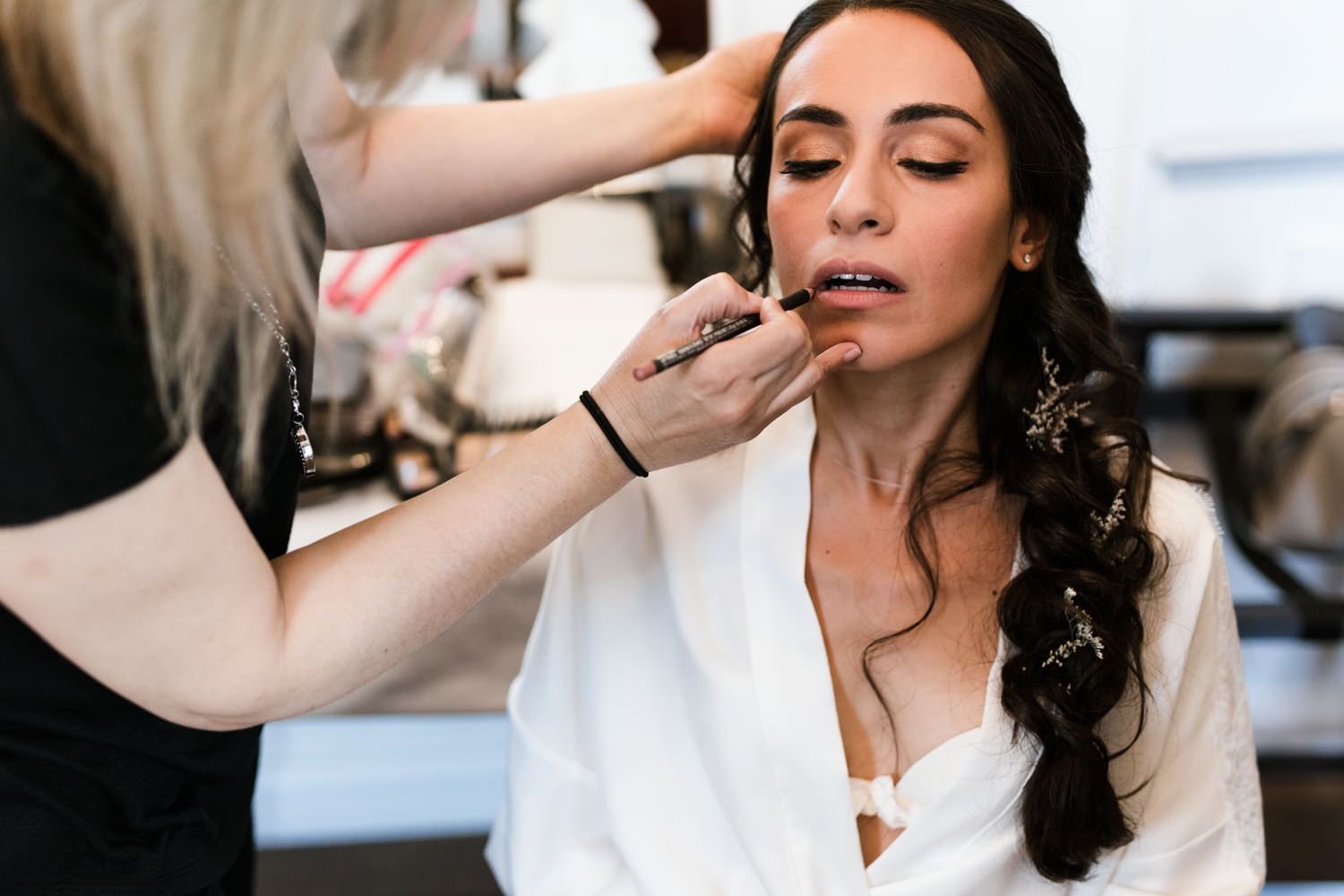 A behind-the-scenes moment of wedding day makeup application.