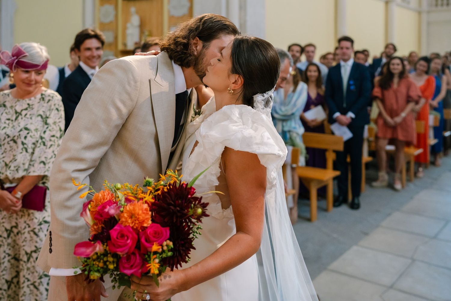 A tender moment shared during a wedding ceremony in a traditional church setting.