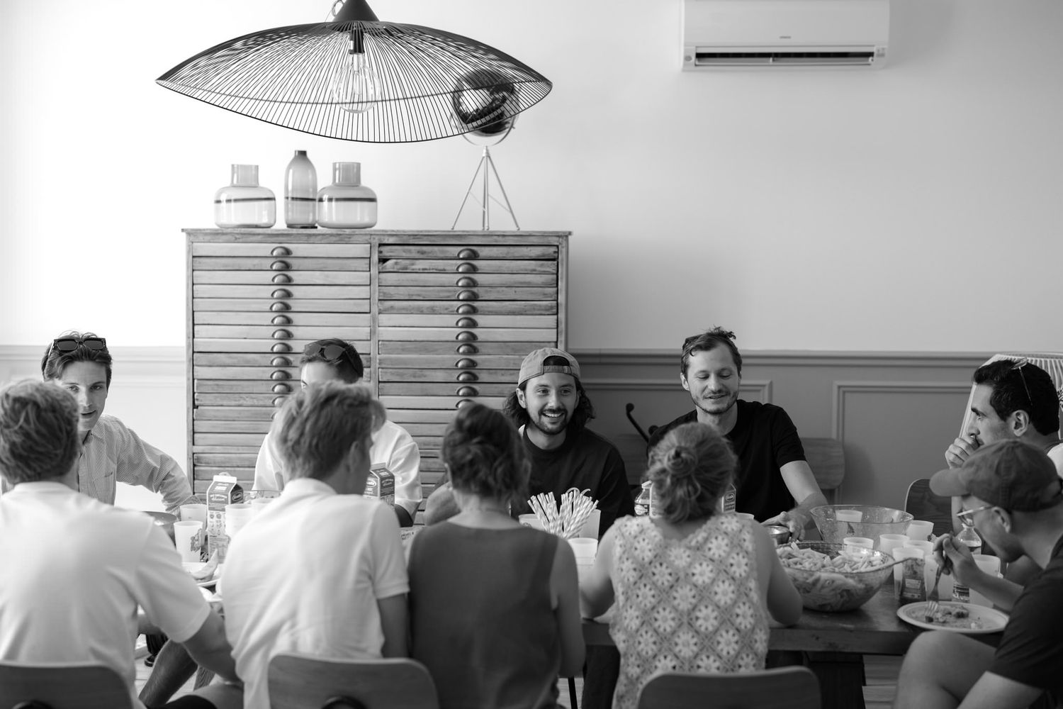 Guests gathered around tables at an indoor social event.