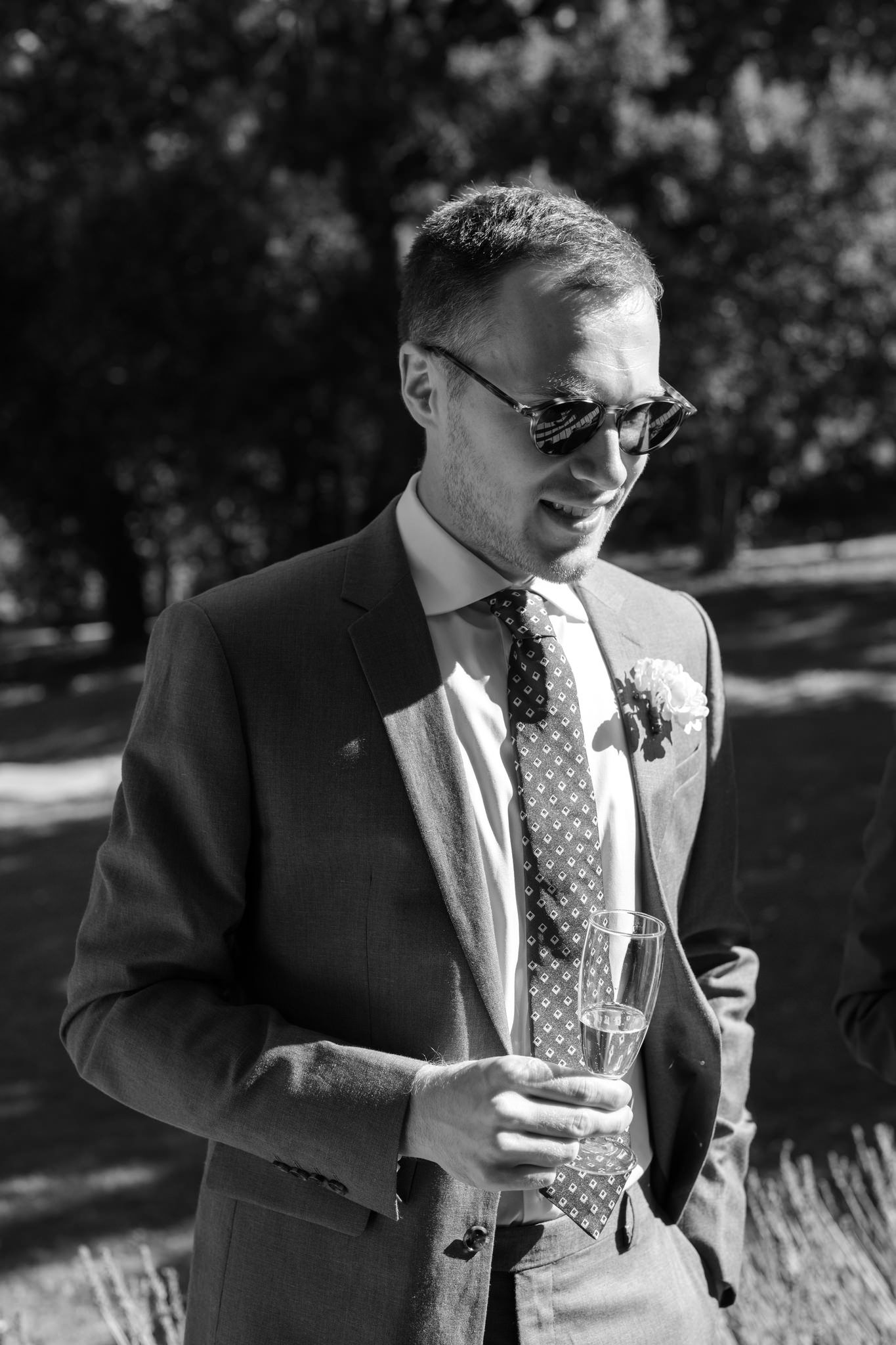 A sequence of black and white photos showing a person in sunglasses drinking from a straw.