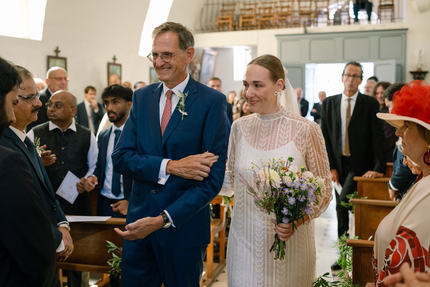 Wedding ceremony taking place inside a bright, traditional church sanctuary.