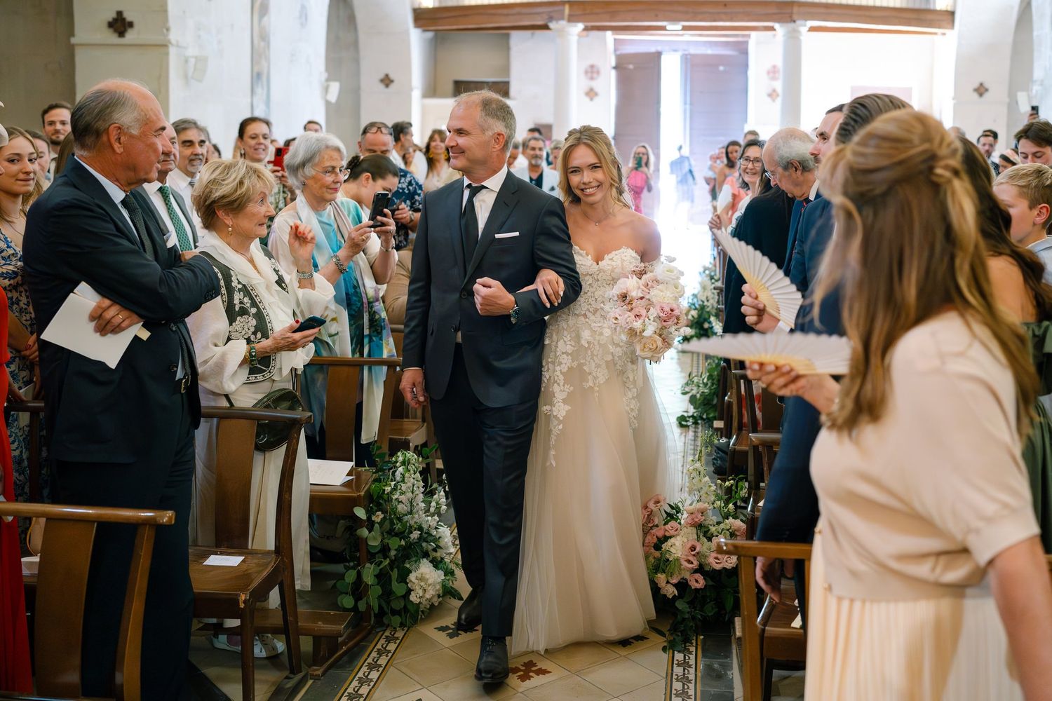 Wedding guests standing in church pews during a traditional ceremony.