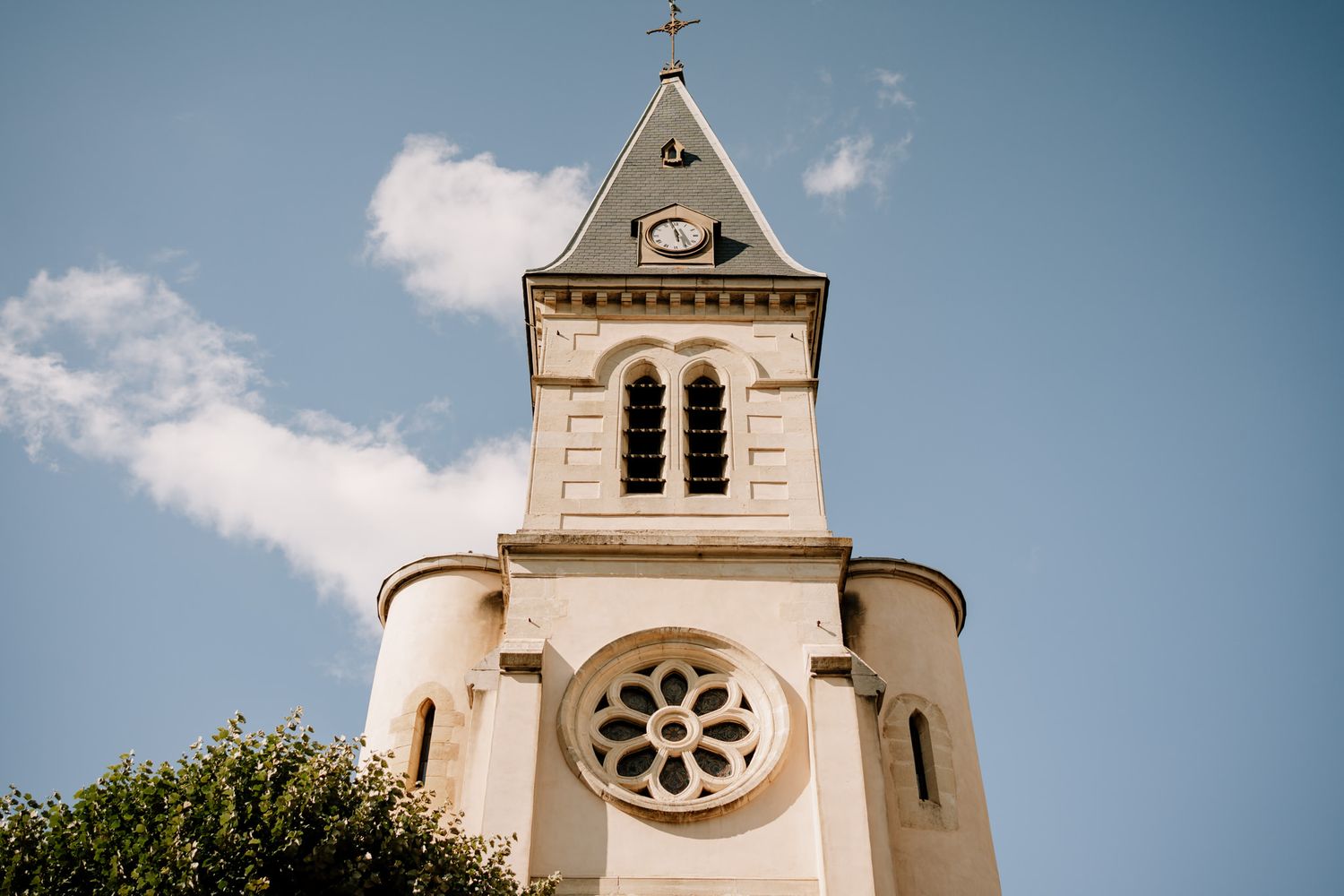 Church steeple and architectural details against blue summer sky.