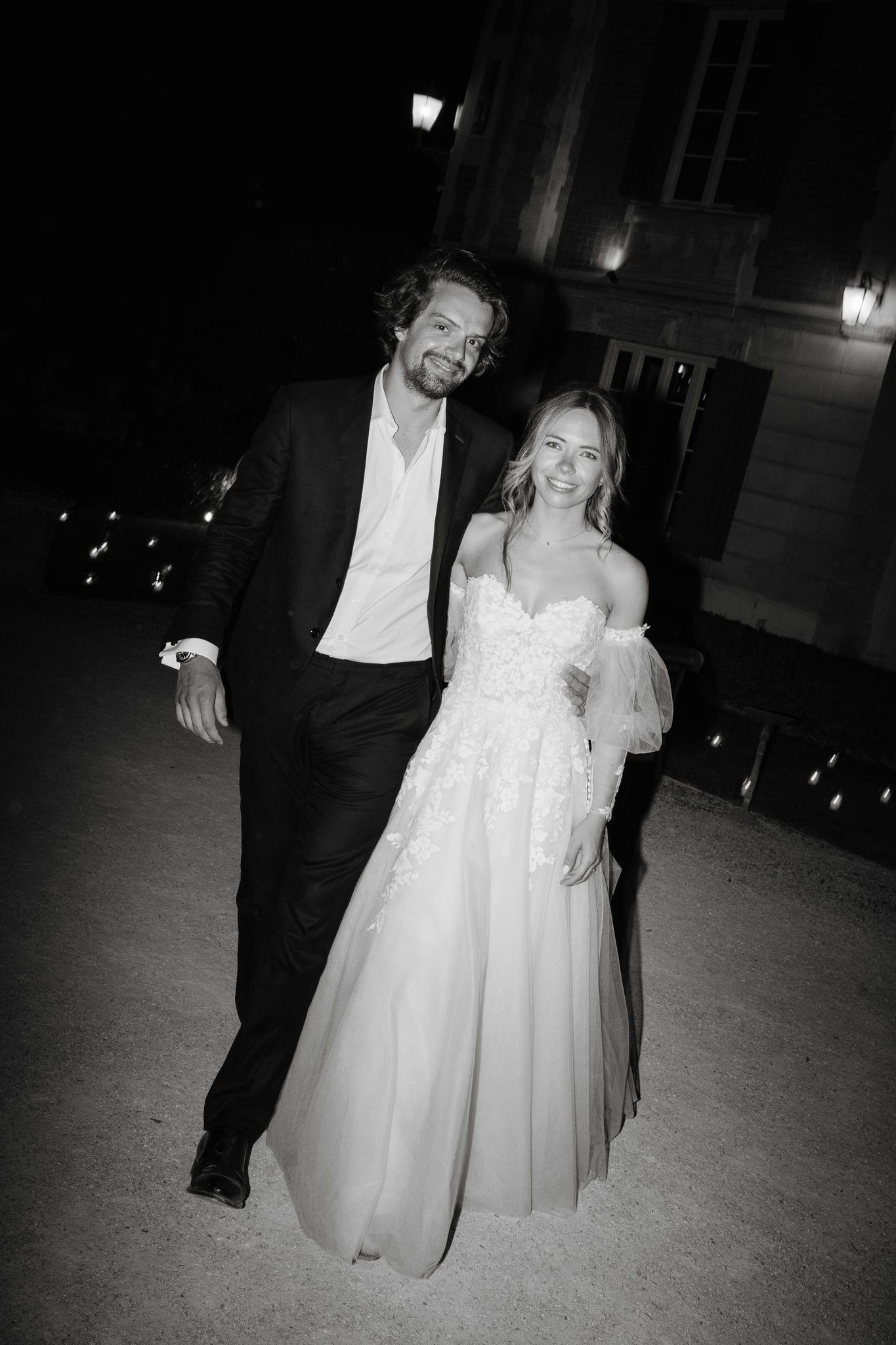 Romantic evening wedding celebration captured in black and white photography.