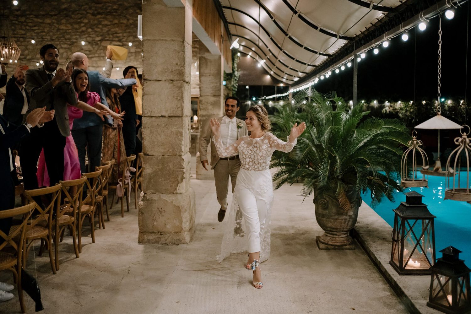 Reception venue decorated with string lights and stone columns creating an elegant atmosphere.