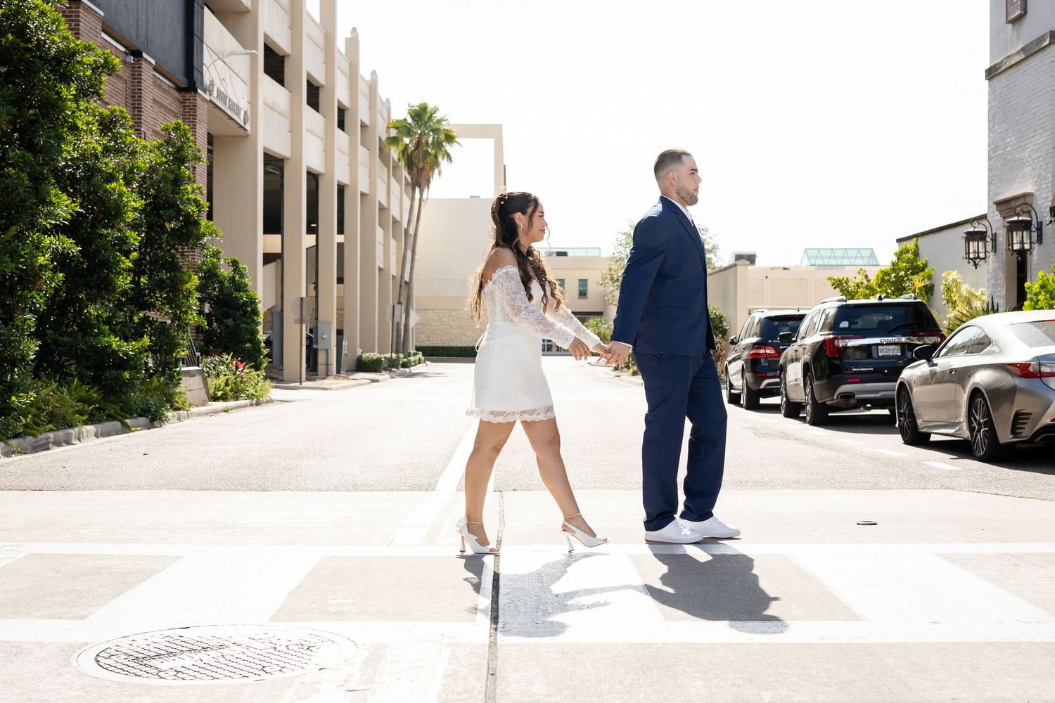 A series of romantic wedding photos showing a couple walking together on a sunny day along palm-lined pathways.