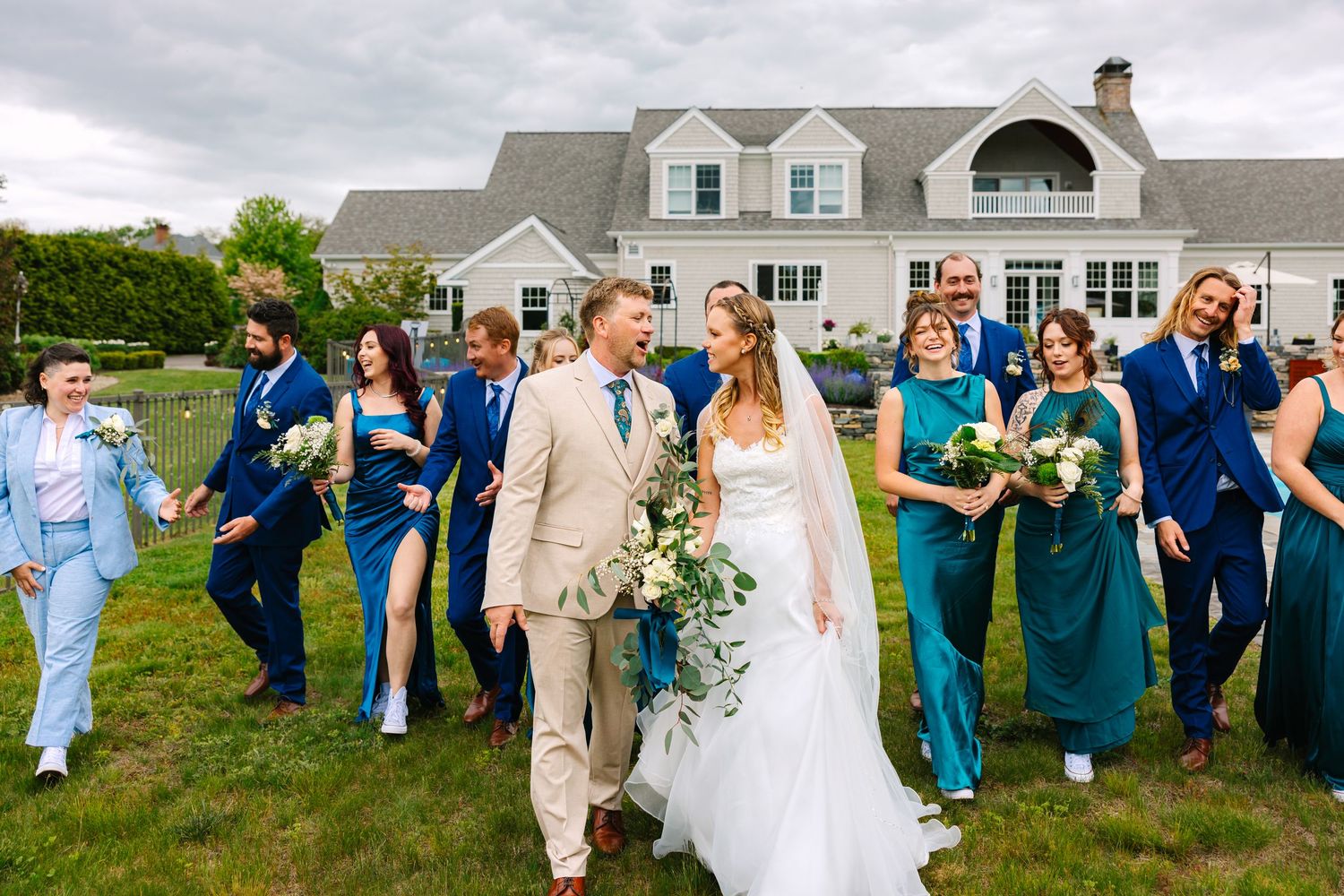 Wedding party candidly walking during portraits at New London County wedding in Connecticut