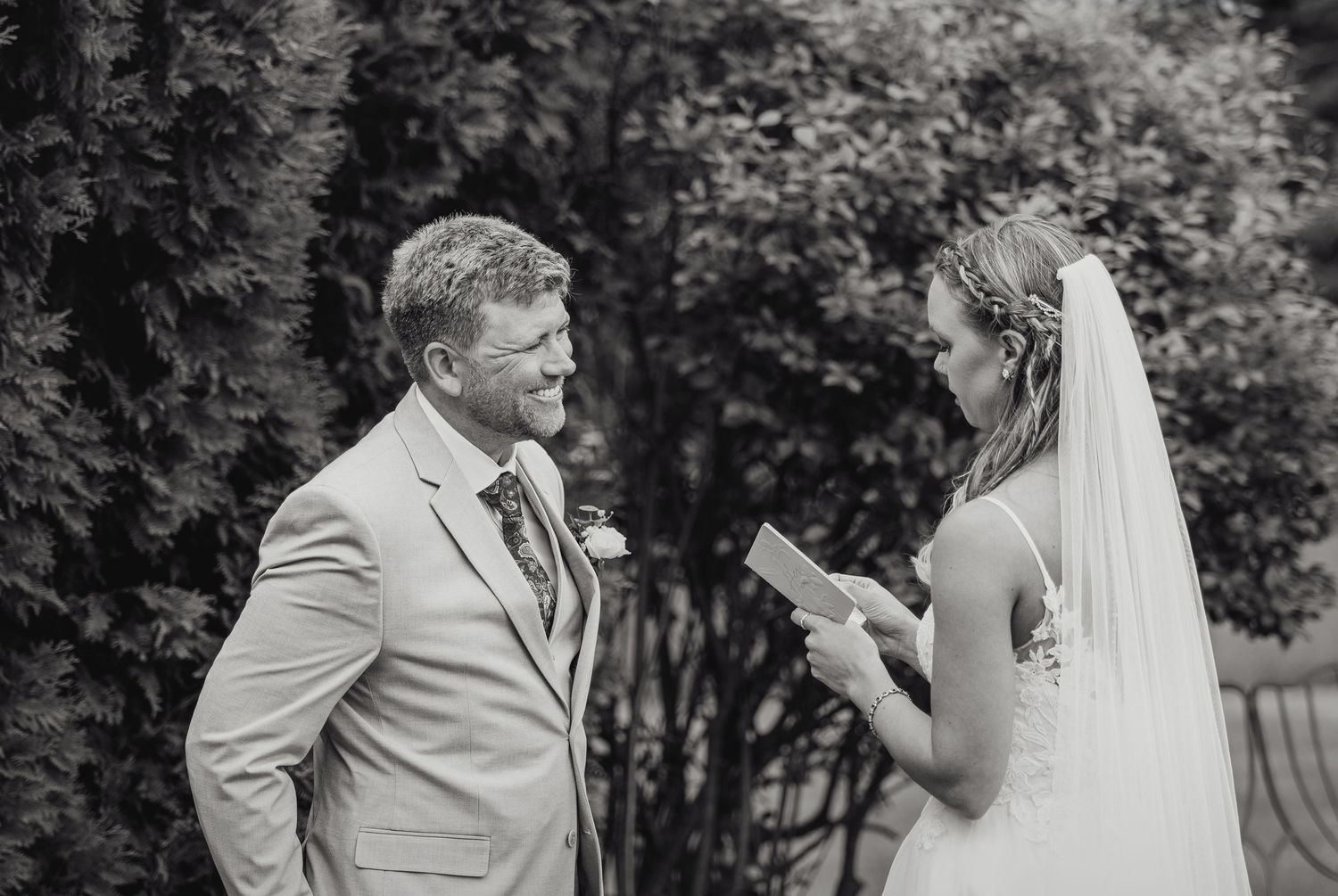 Black and white wedding photo collage showing intimate moments between newlyweds in an outdoor garden setting.