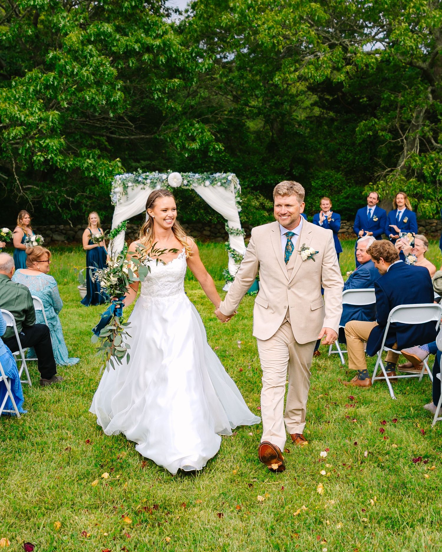 Bride and groom cheerfully exiting their backyard  intimate wedding ceremony in New London County Connecticut