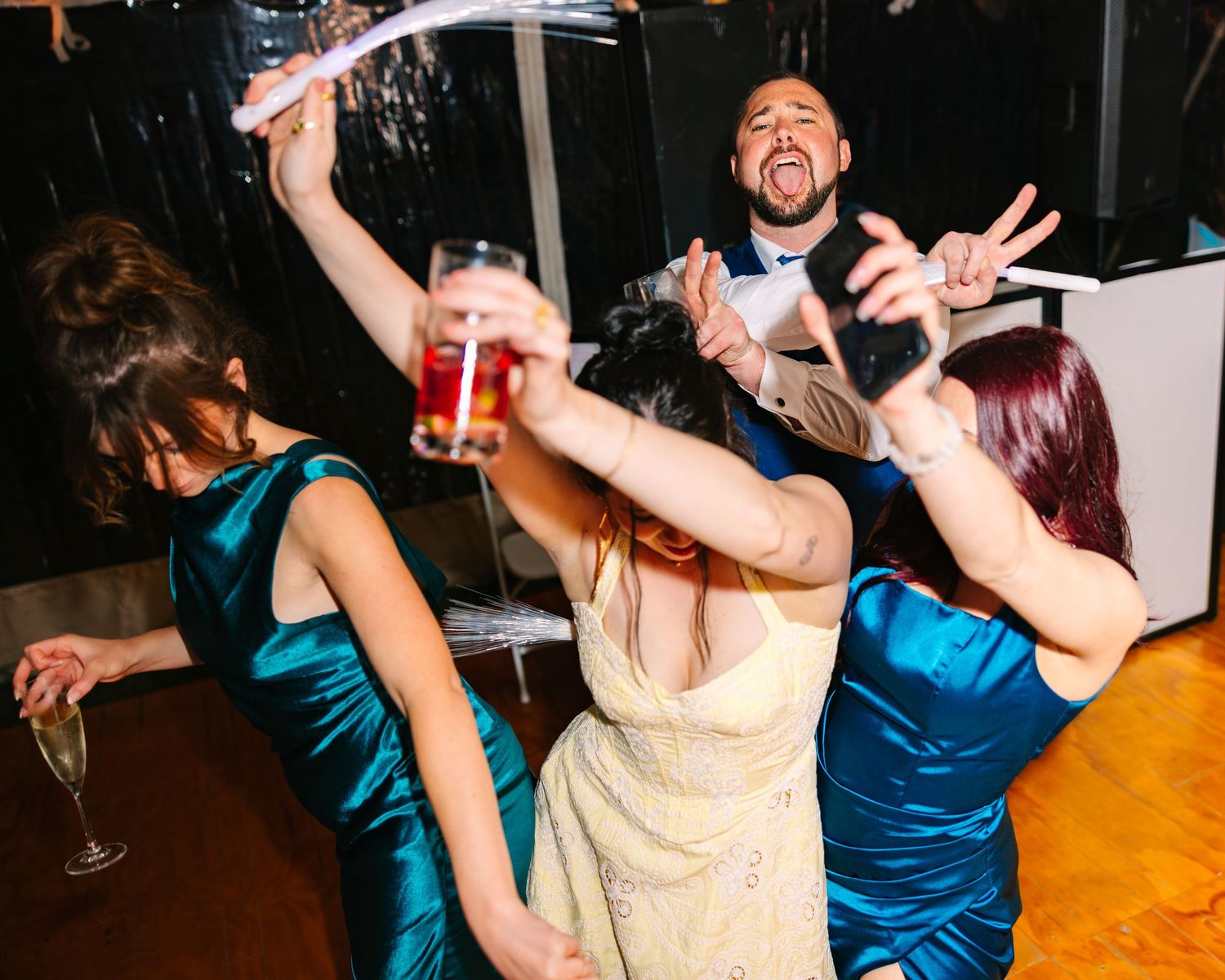 Candid flash reception photo of guests dancing in a tented dimly lit wedding venue in New London County Connecticut