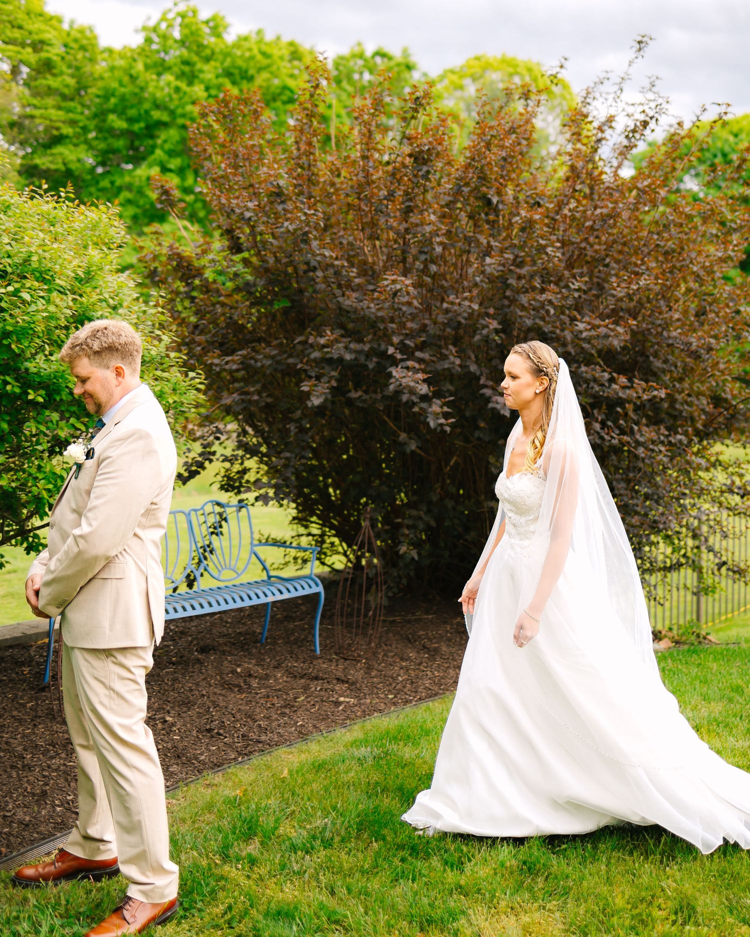 A playful sequence of photos showing a couple chasing each other around a bush in a garden setting.