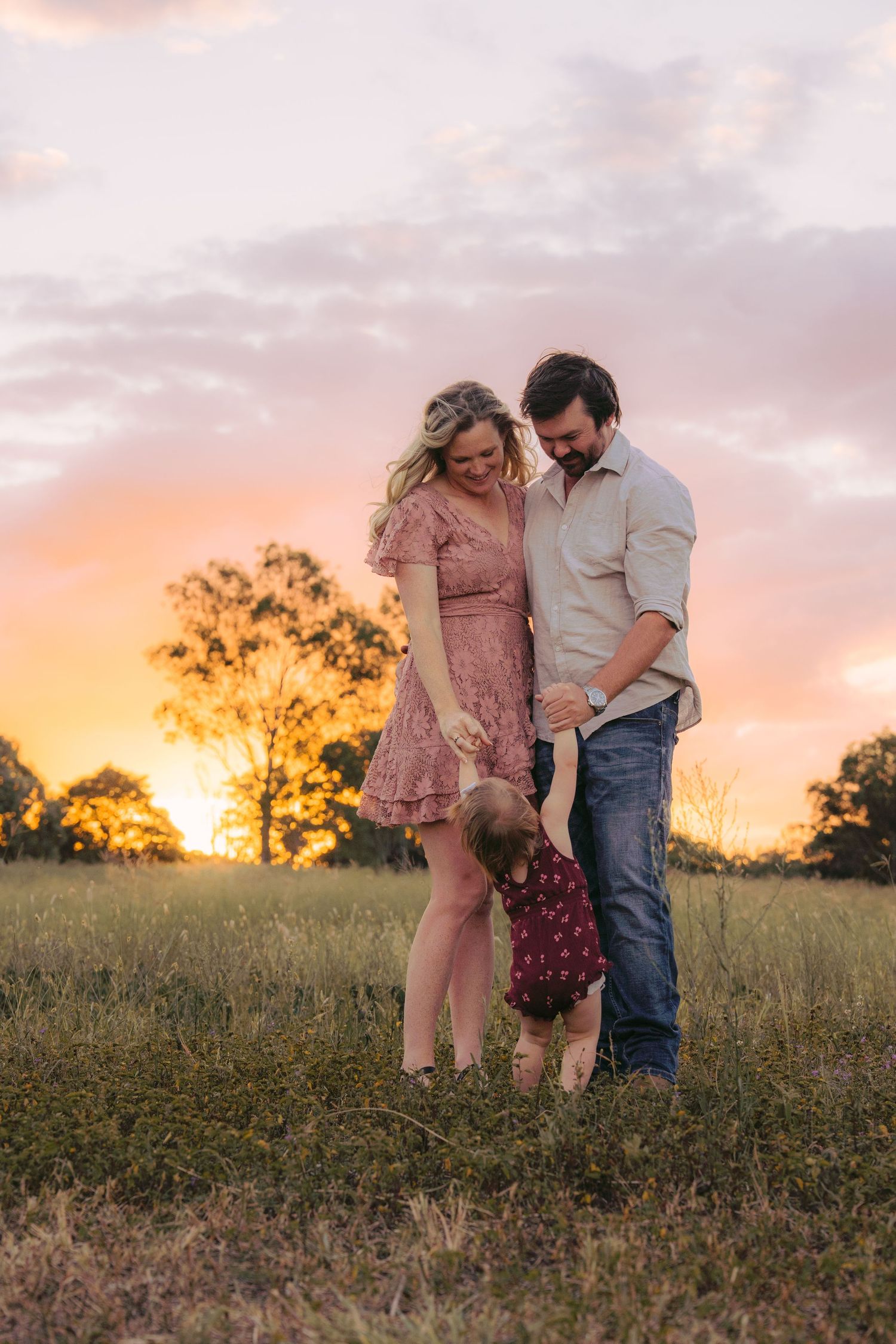 Family embracing during sunset on their family session