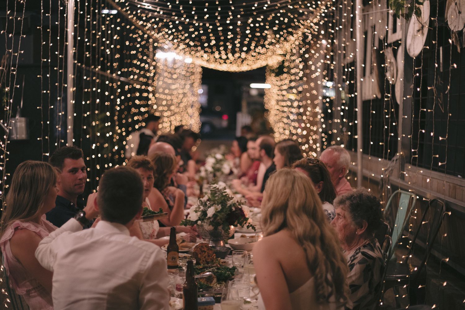 Romantic fairy light tunnel creating a magical atmosphere during the wedding reception.