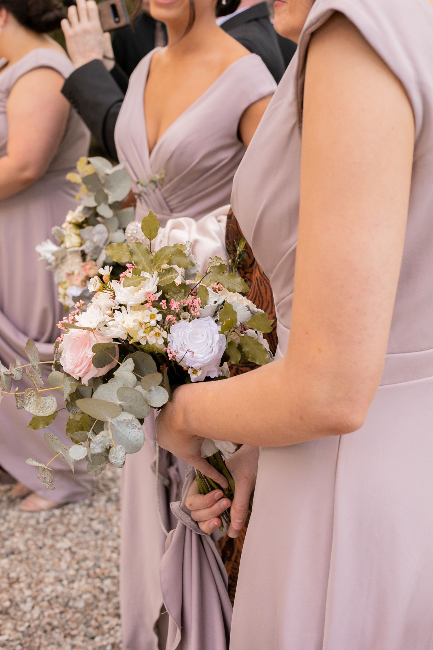 Bridal bouquet held by the wedding party, featuring elegant floral details and soft natural tones.