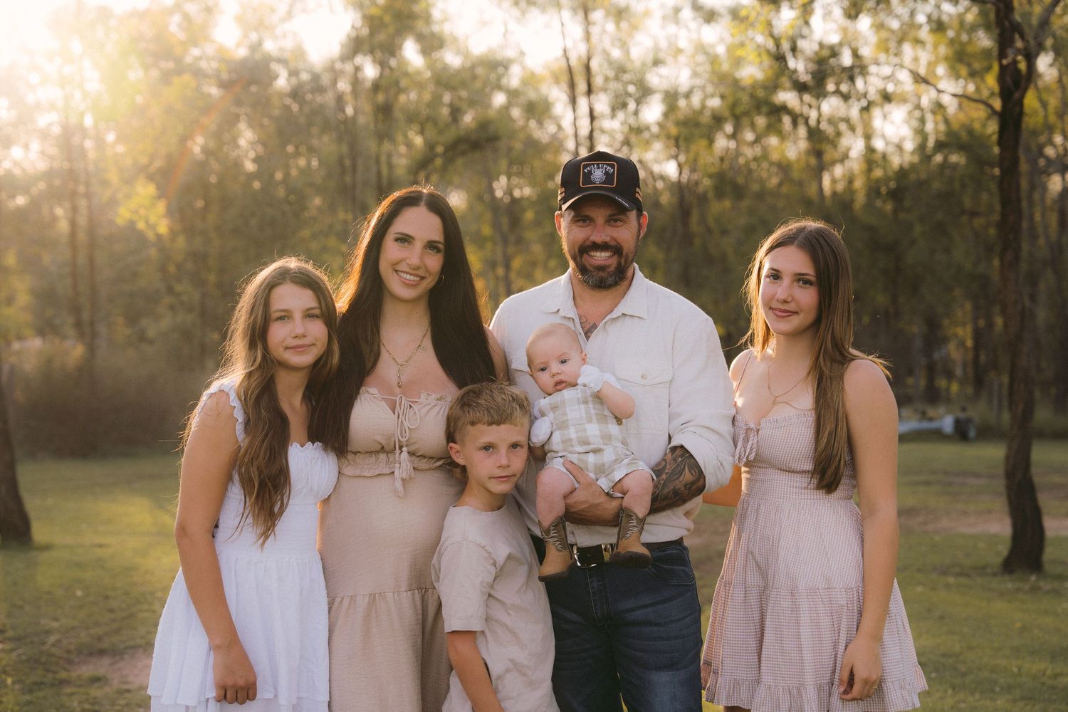 Newest family member joins for updated family photos during golden hour