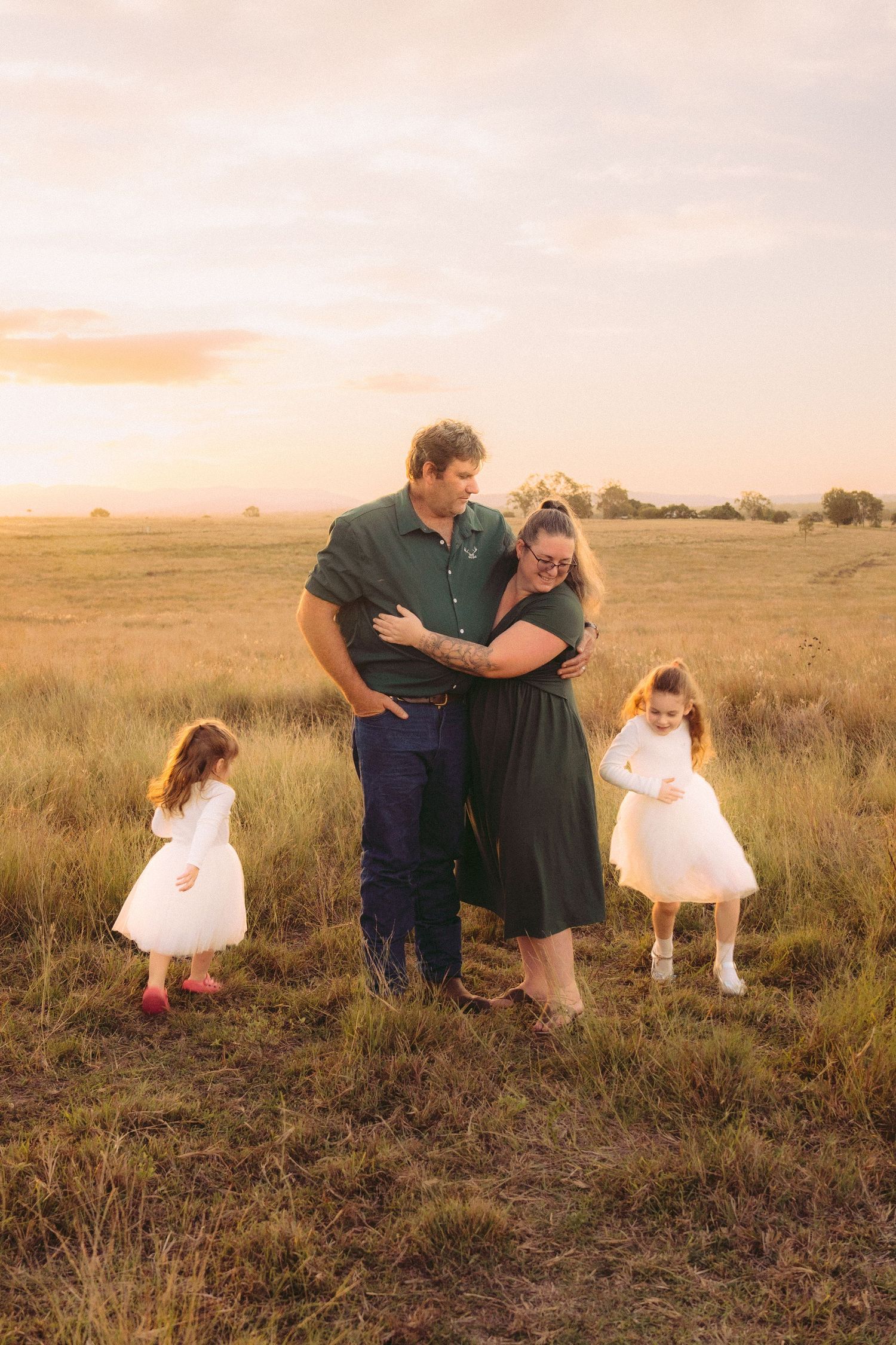 Children running around parents during golden hour on their family session