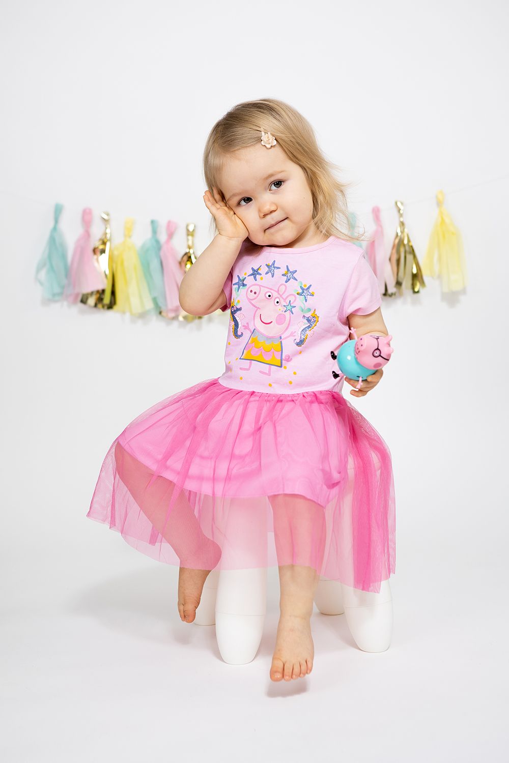 Baby girl in a two year old photoshoot in studio white background.