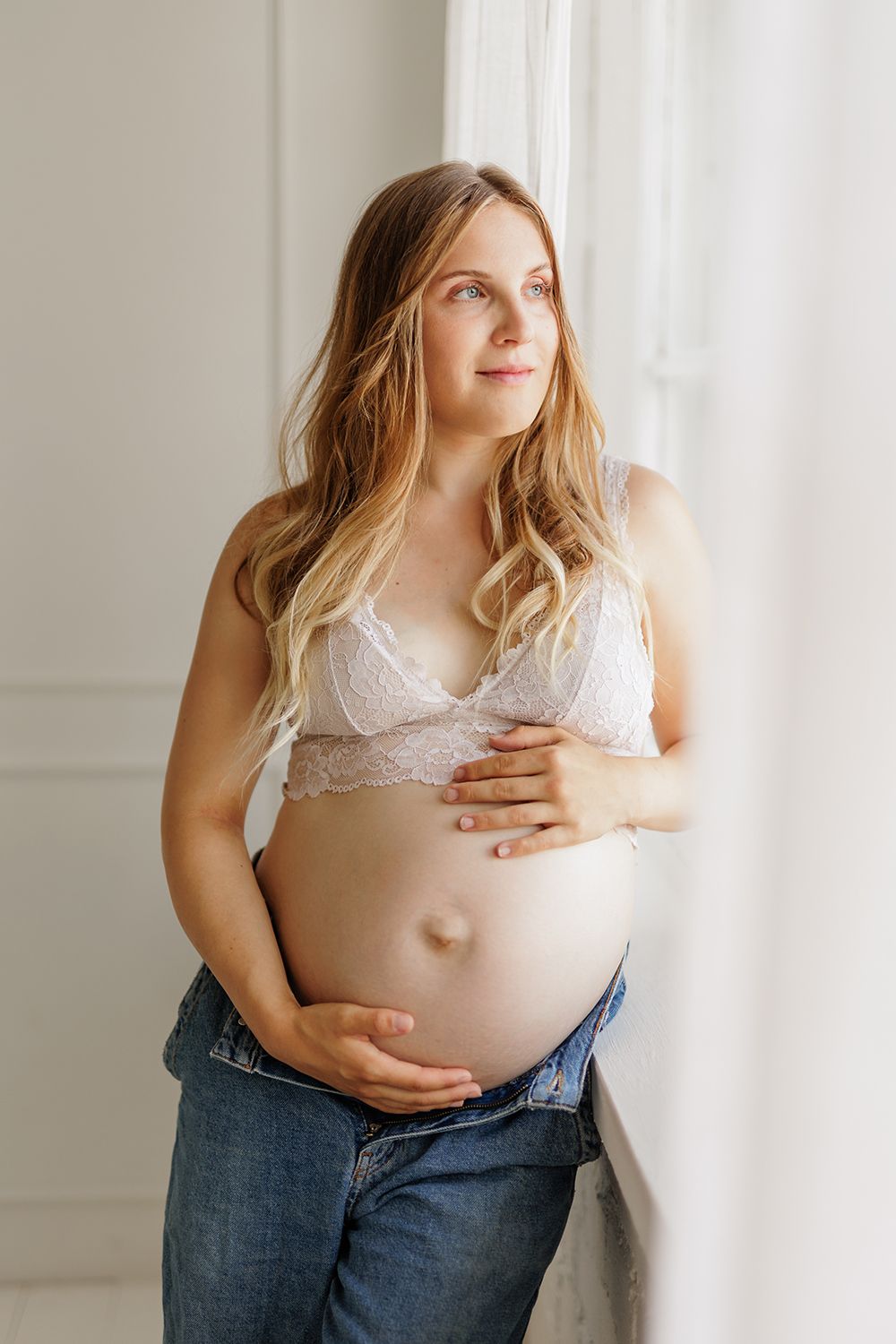 An expecting mother holding a baby bump.