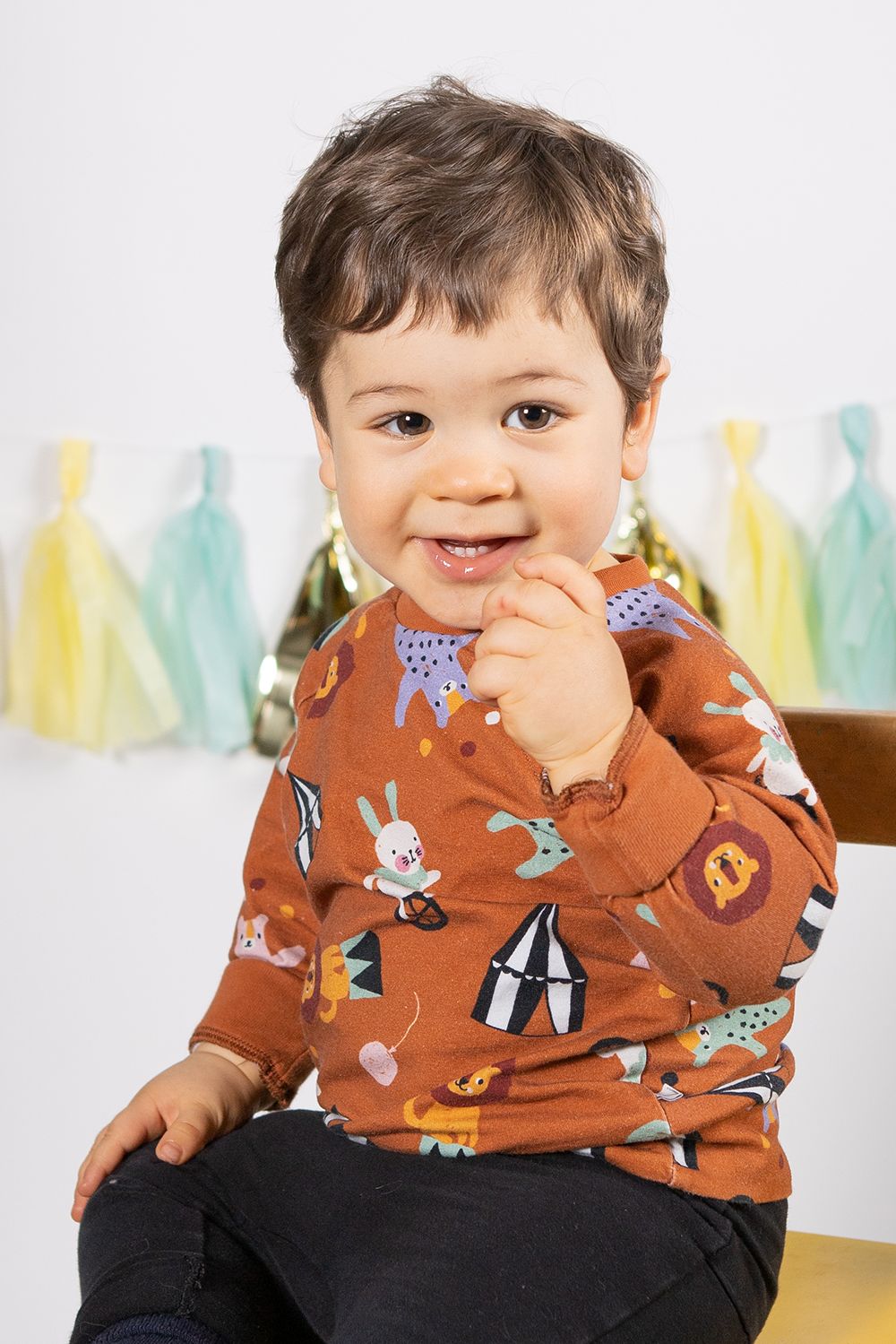 Baby boy in a one year old photoshoot in studio white background.