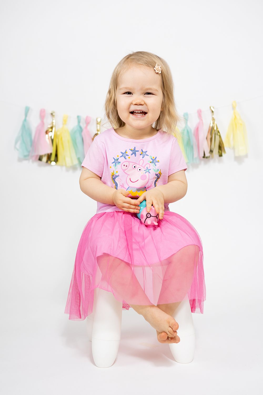 Baby girl in a two year old photoshoot in studio white background.