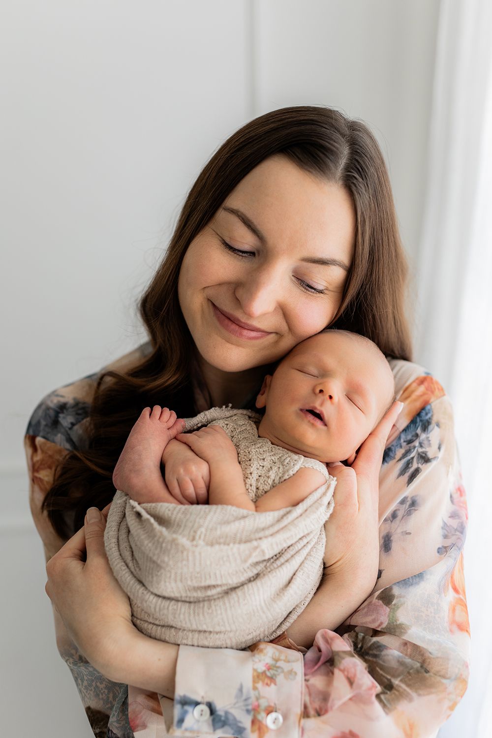 A mother holding a newborn baby.