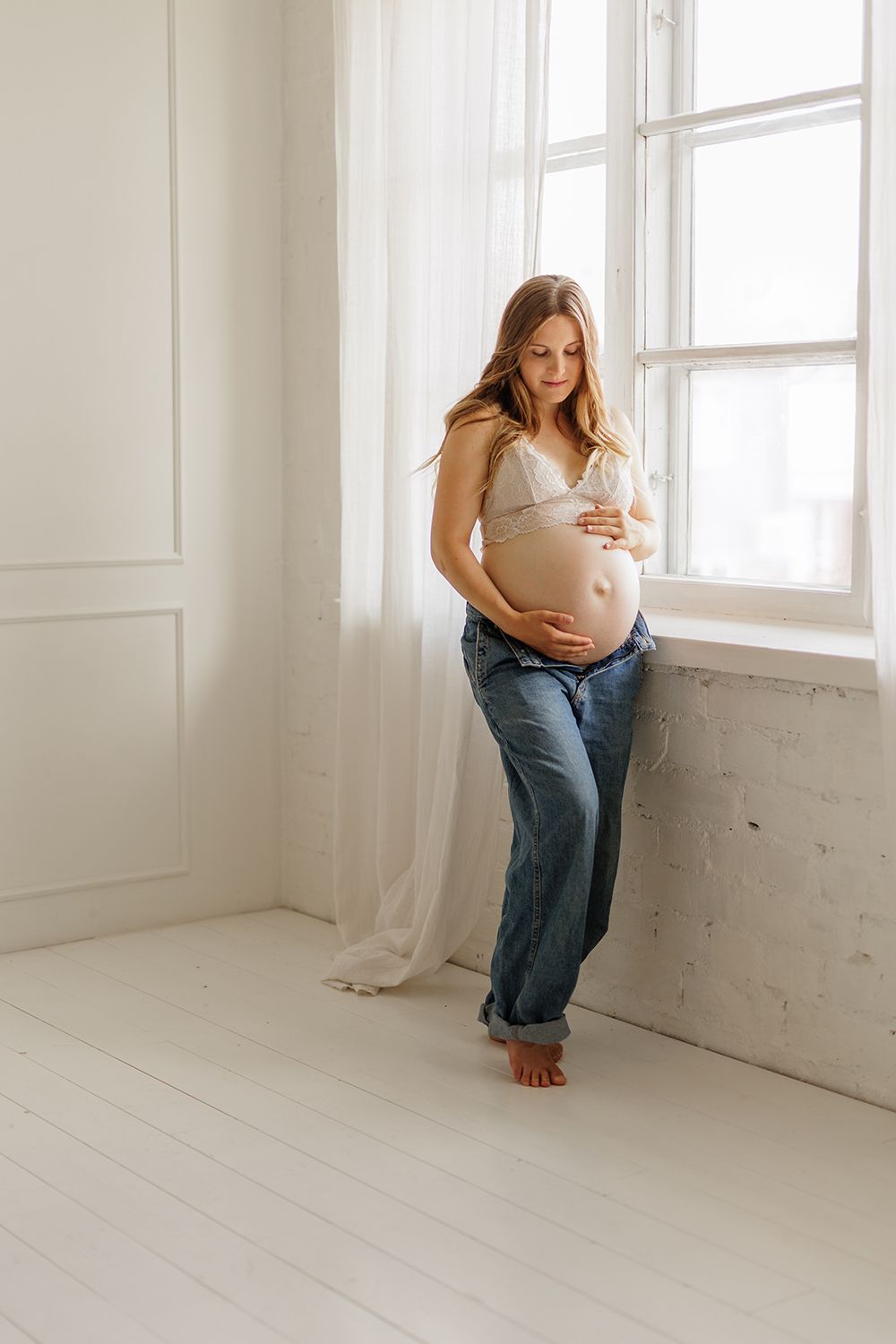 An expecting mother holding a baby bump.