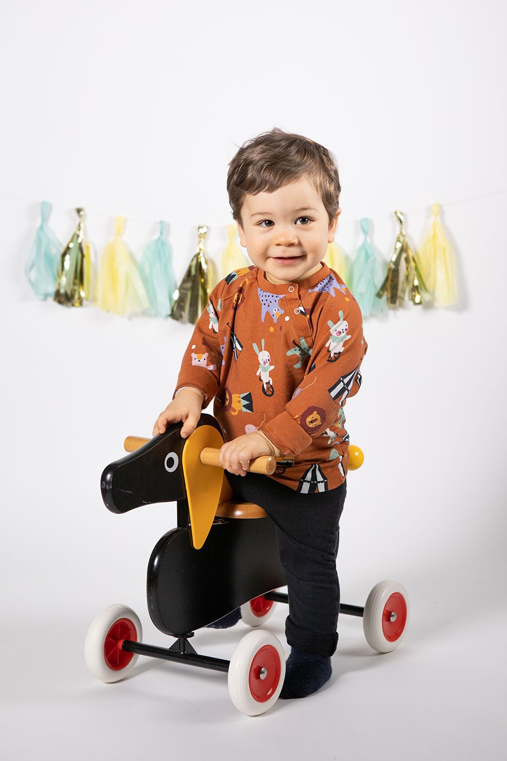 Baby boy in a one year old photoshoot in studio white background.
