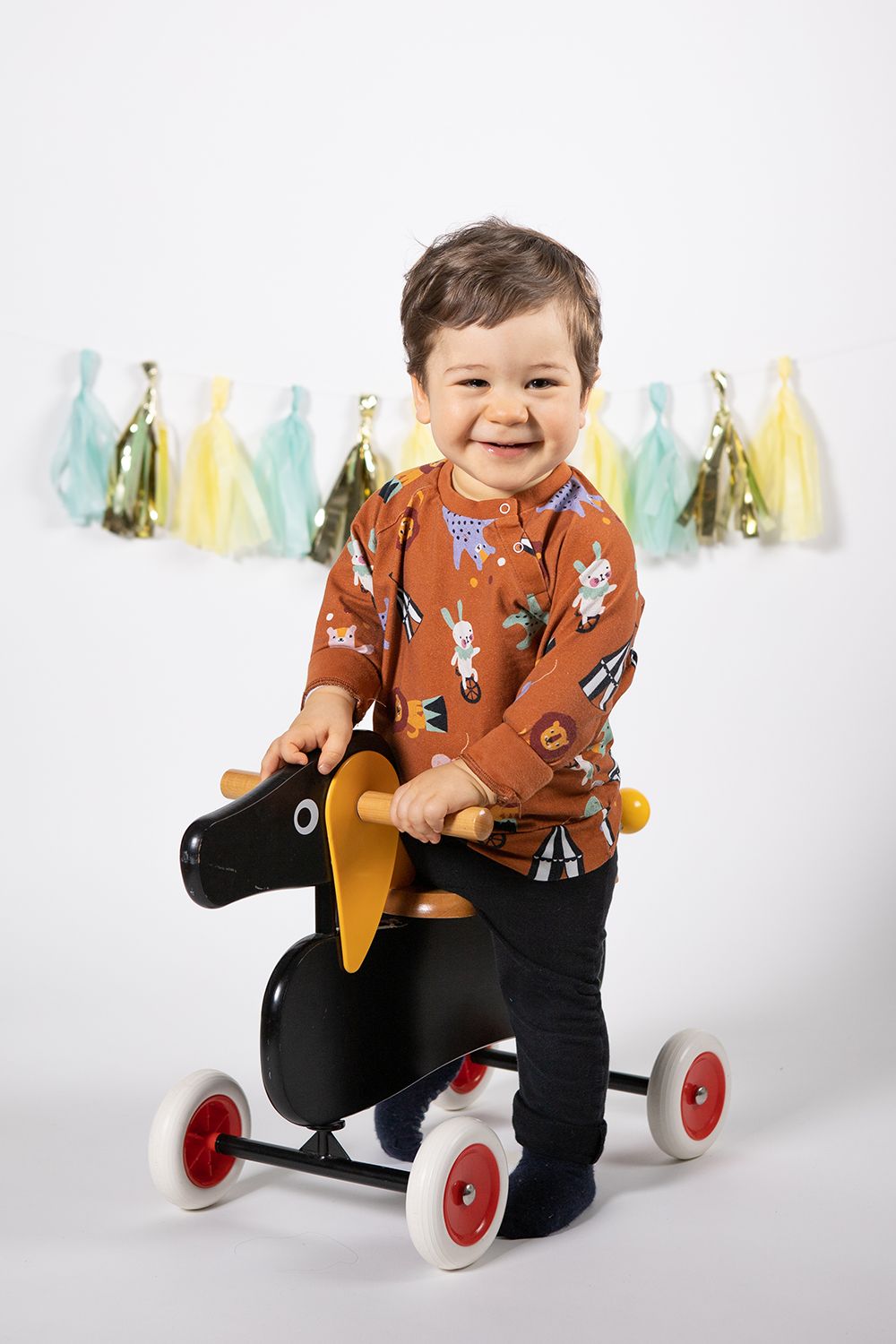 Baby boy in a one year old photoshoot in studio white background.