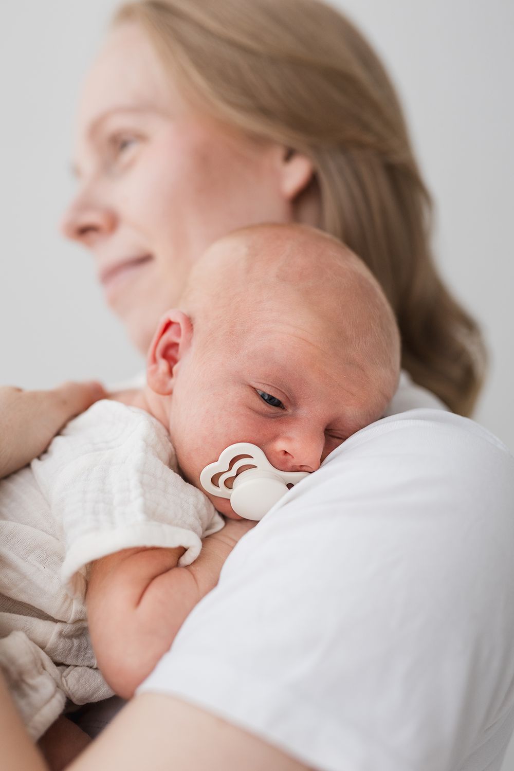A mother holding a newborn.