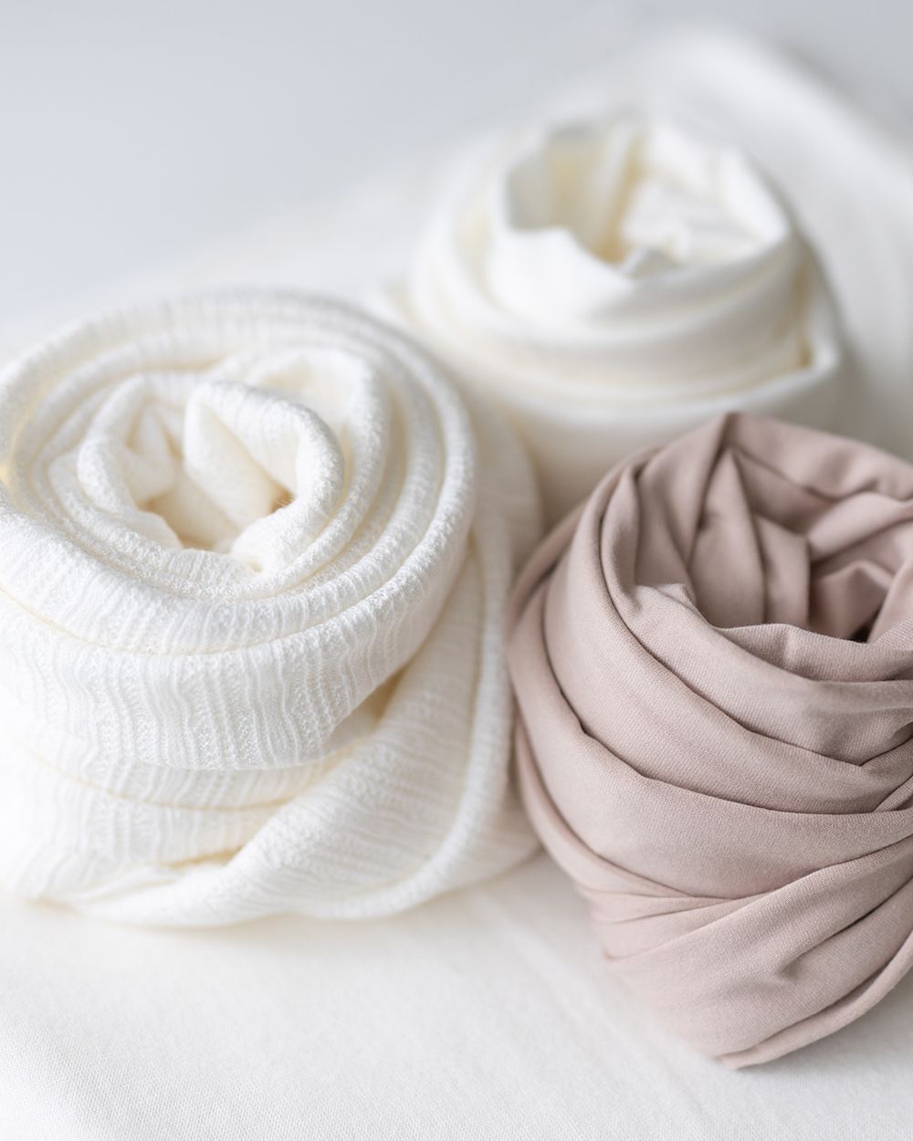Newborn photoshoot wraps in neutral color.