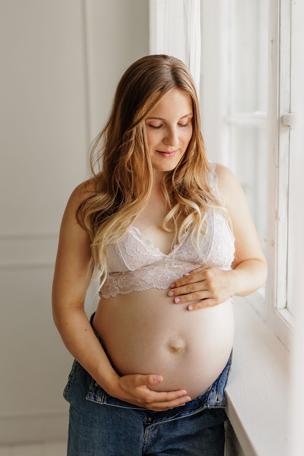An expecting mother holding a baby bump.