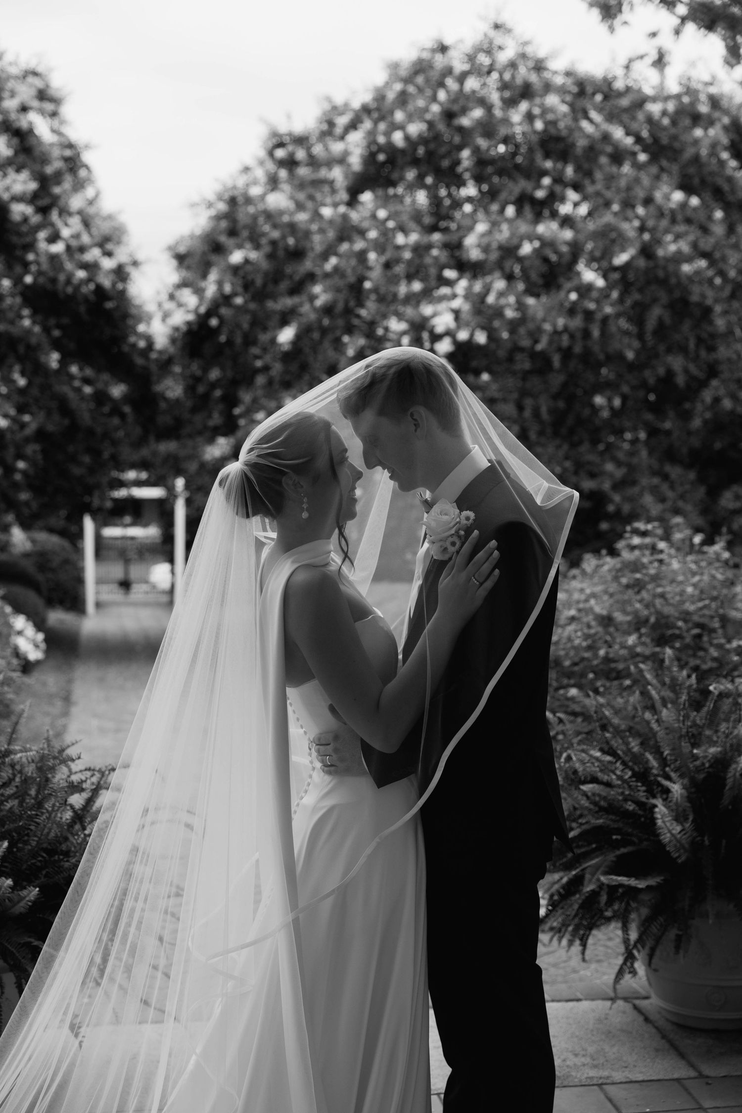 bride and groom under brides veil