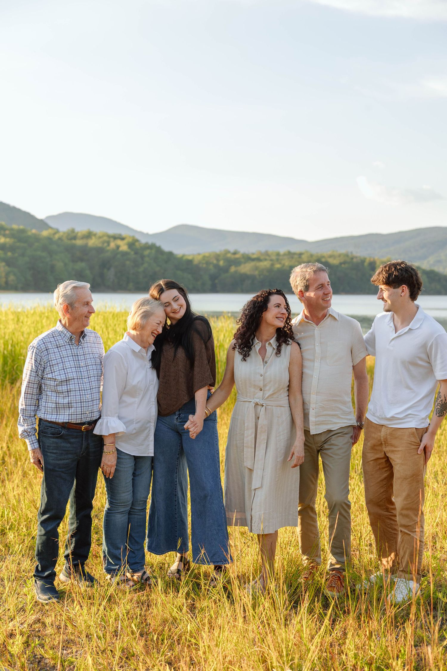family photo in front of a lake with mountains