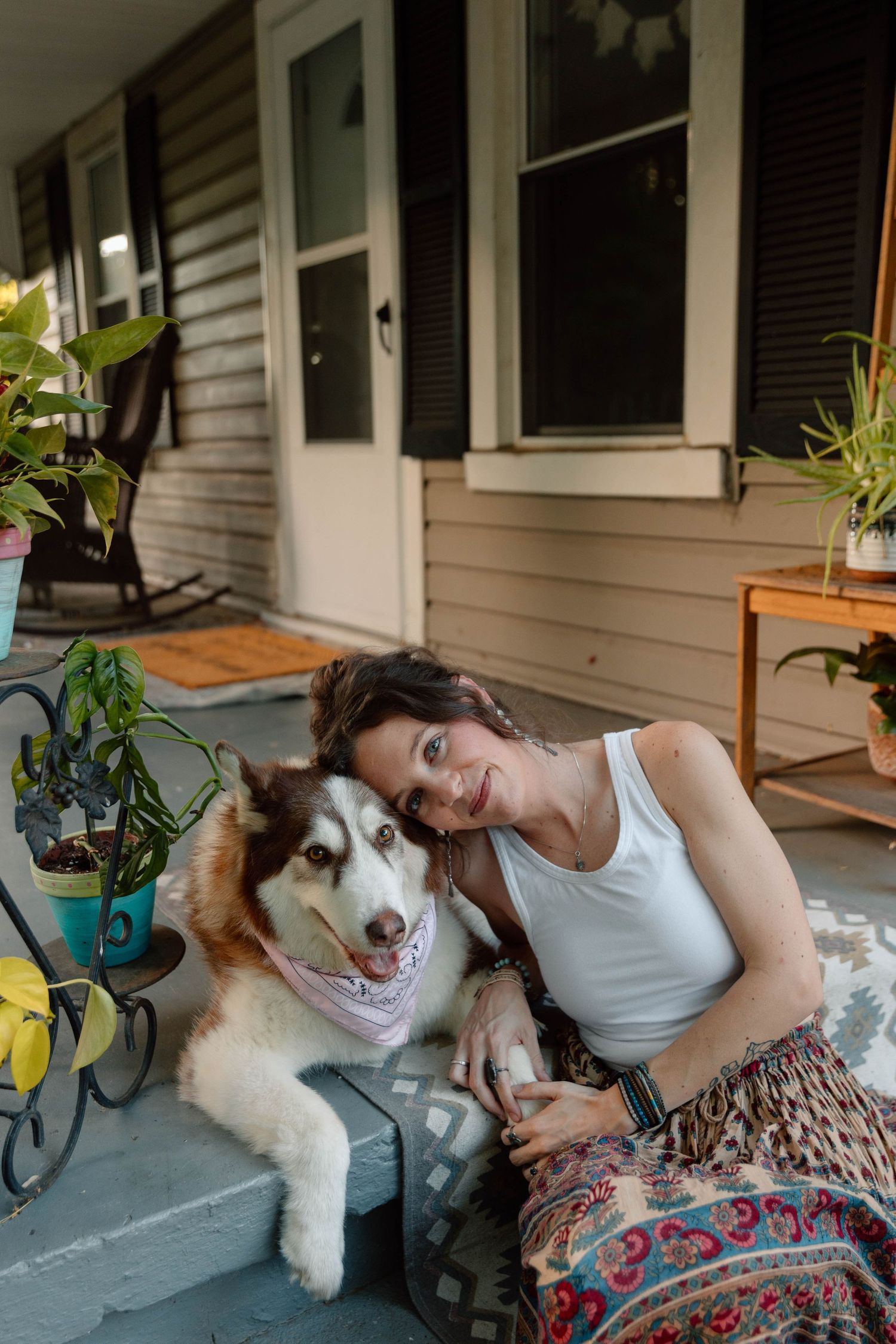 woman and her dog cuddling on steps
