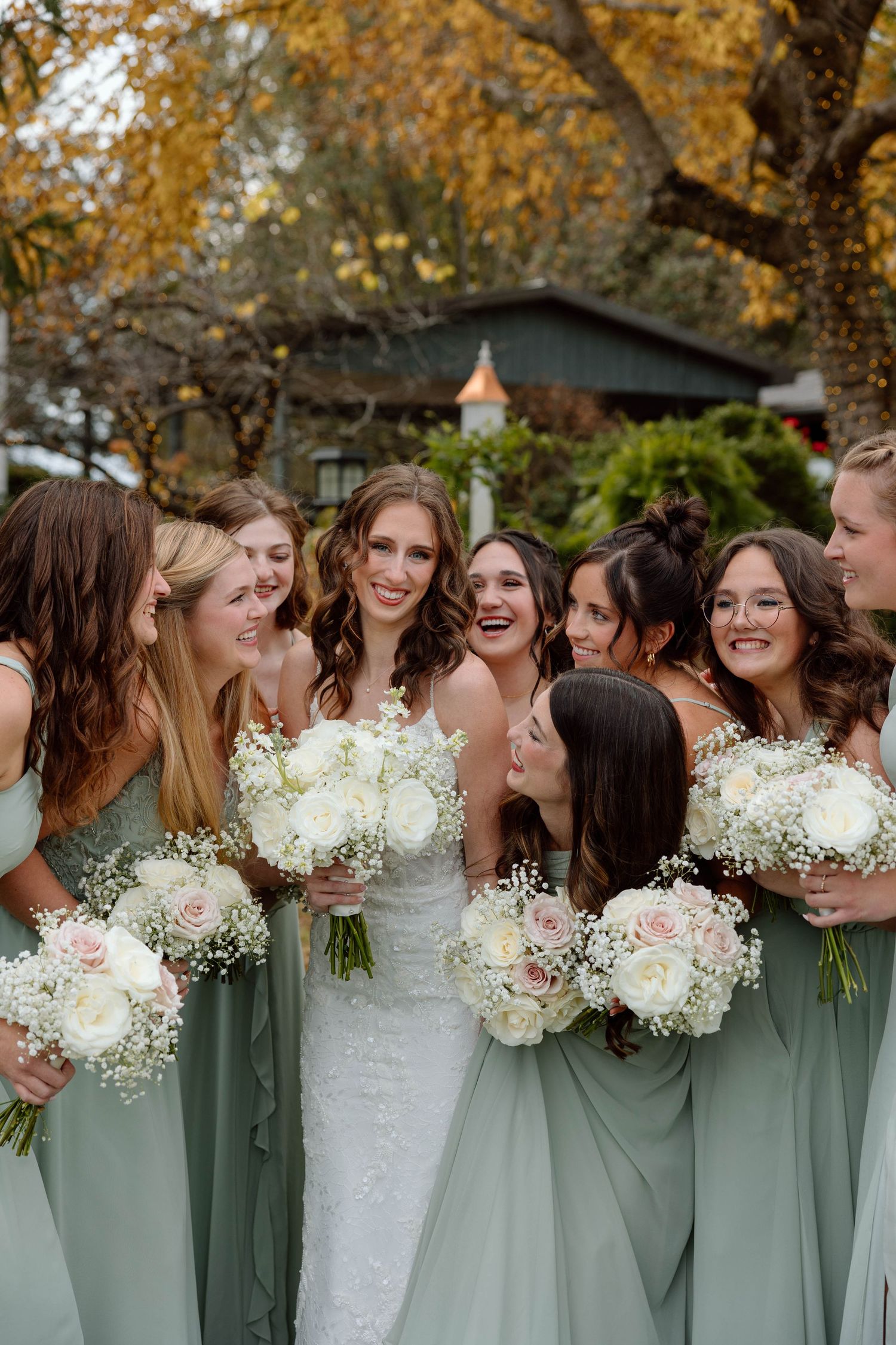 bride with her bridesmaids smiling looking at her