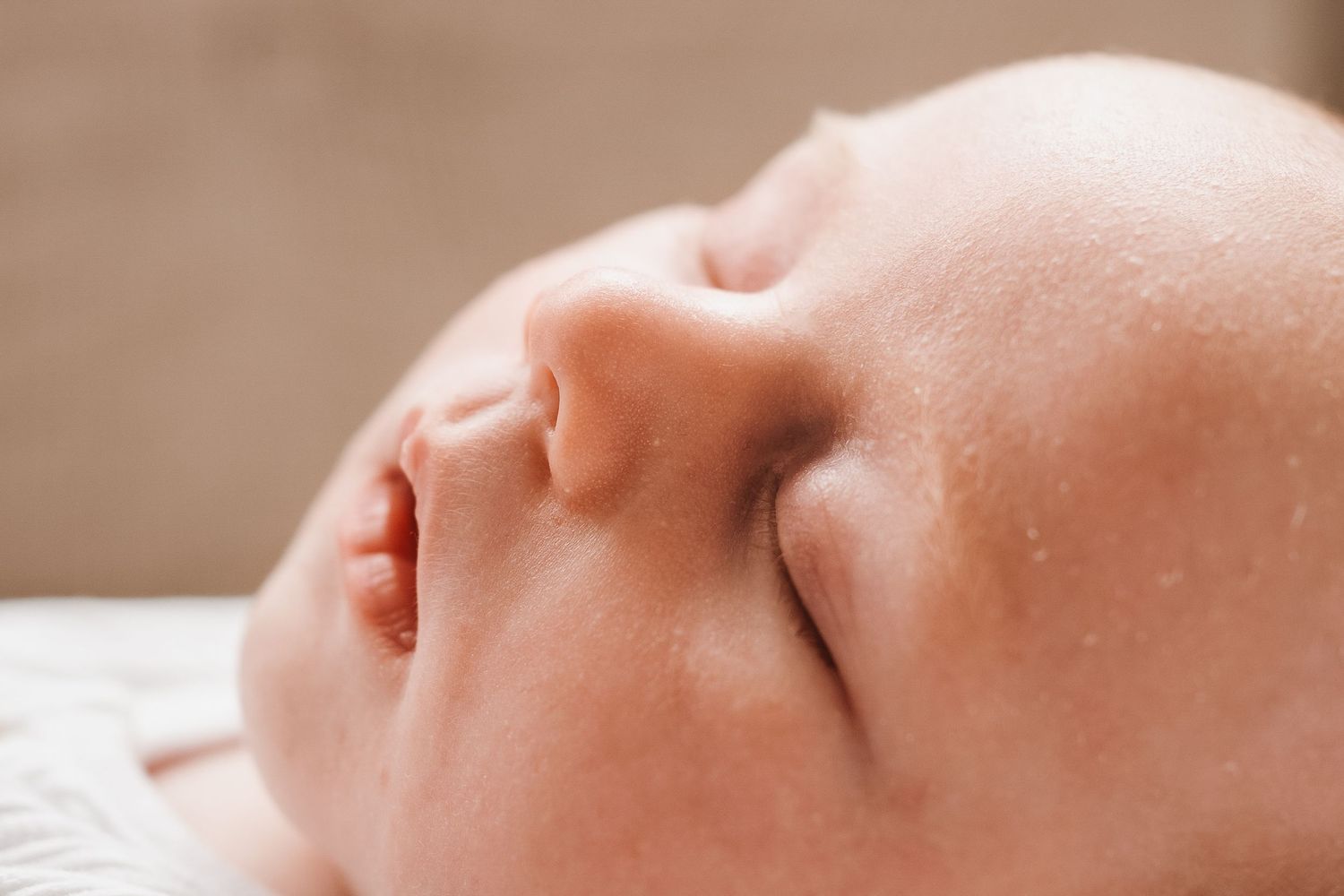 Close-up of a peaceful sleeping newborn baby with soft skin and delicate features.