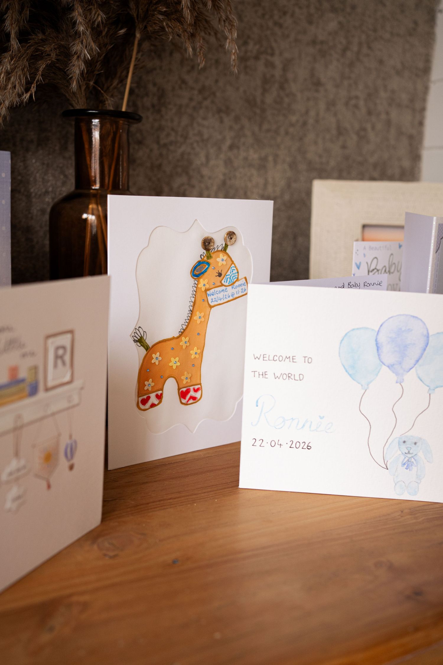 Welcome to the world baby cards with giraffe and balloon designs.